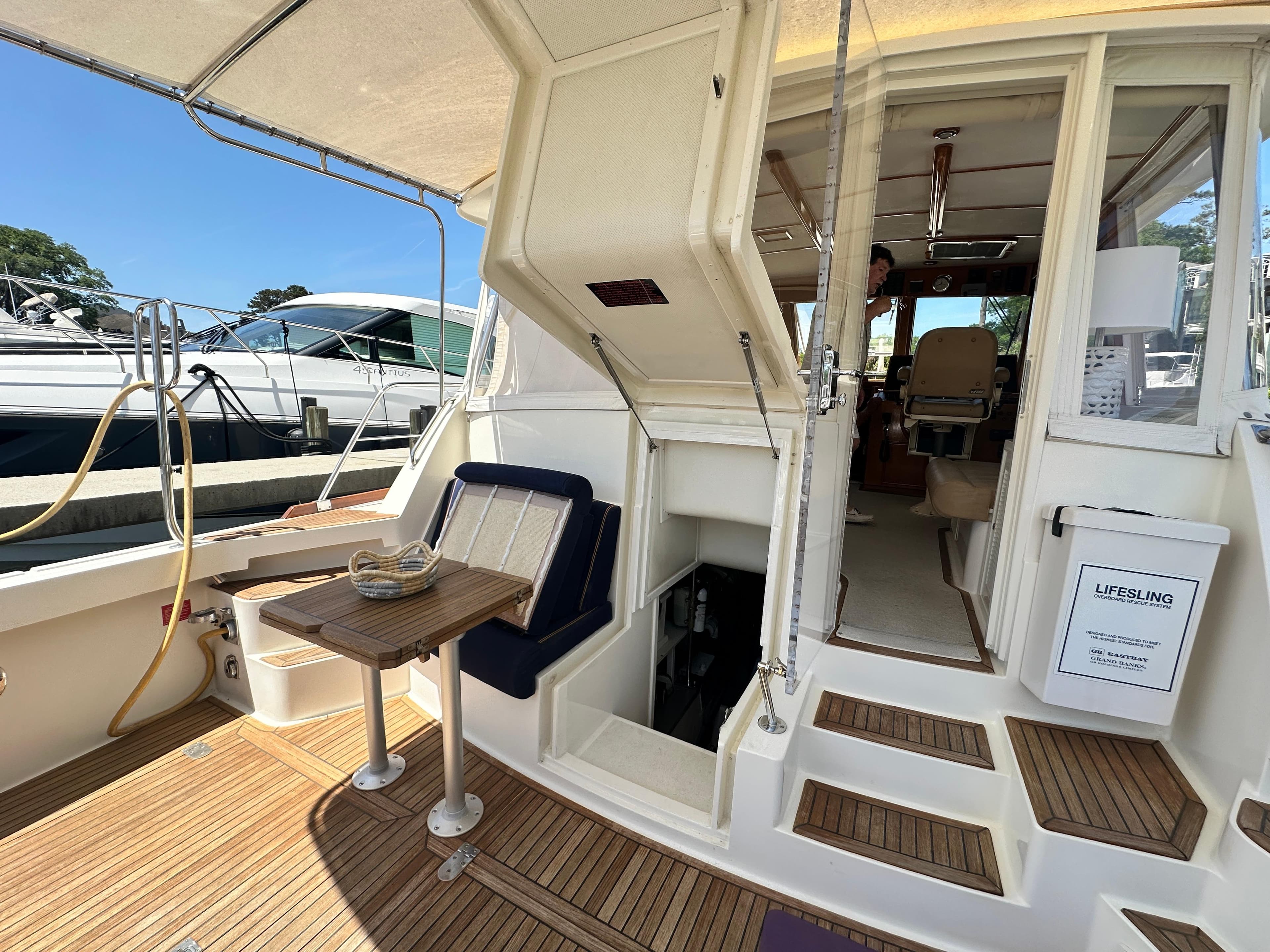 2004 Grand Banks 49 Eastbay HX yacht interior with seating and wooden flooring.
