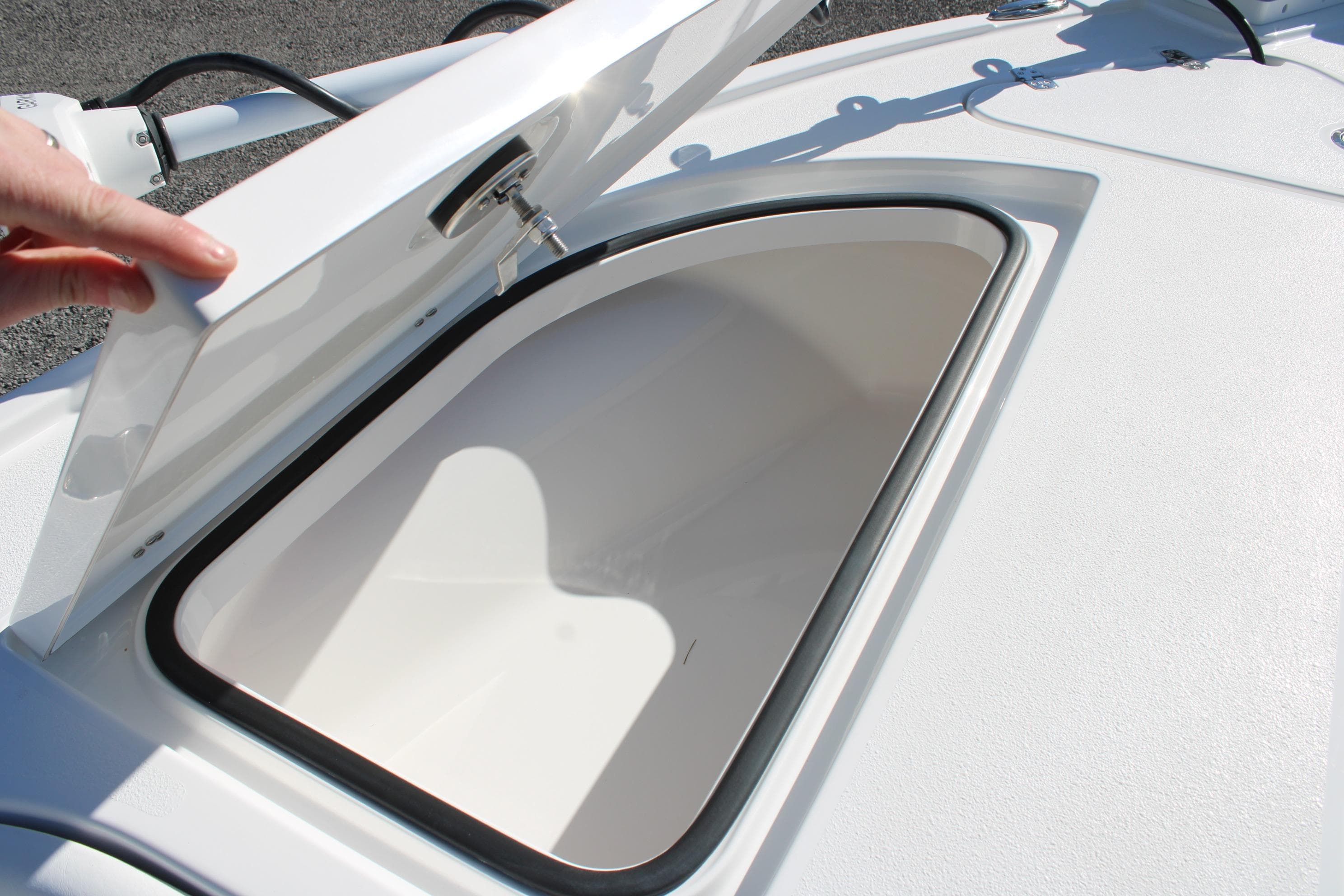Open storage compartment on 2026 Blazer Bay 2440 boat, showcasing interior space.