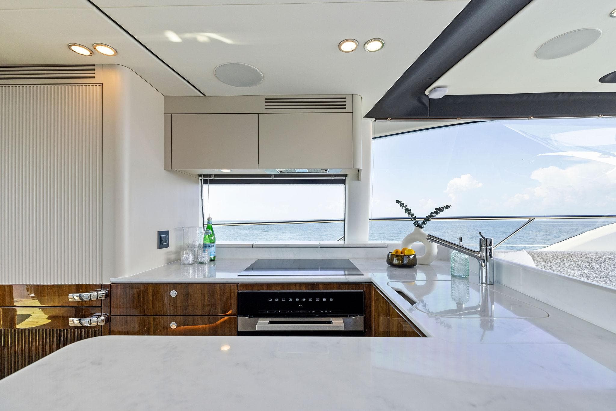 Luxurious kitchen interior of 2024 Fairline Phantom 65 yacht with ocean view.