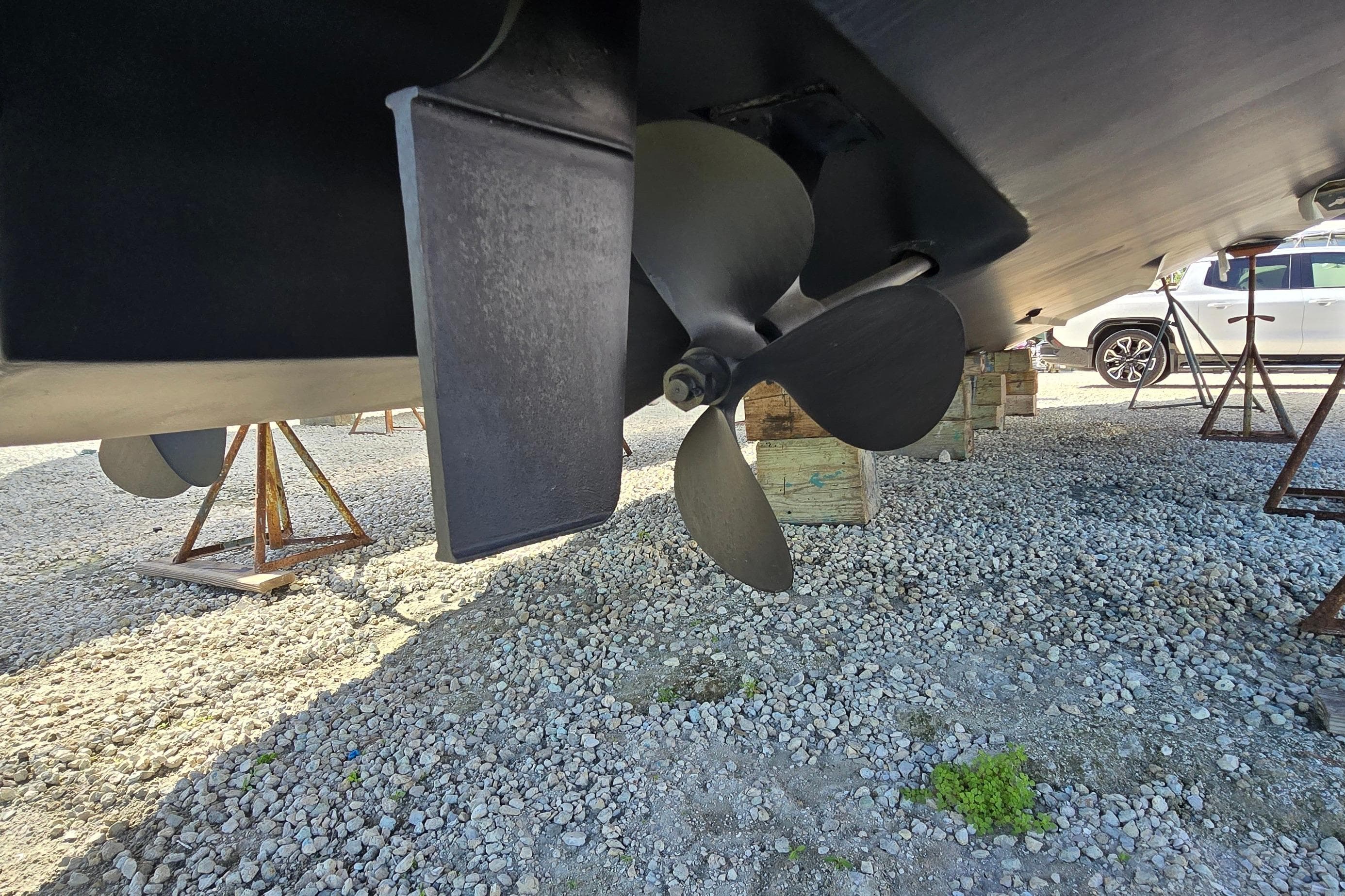 Propeller and rudder of 2001 Sea Ray 400 Sedan Bridge on dry dock.