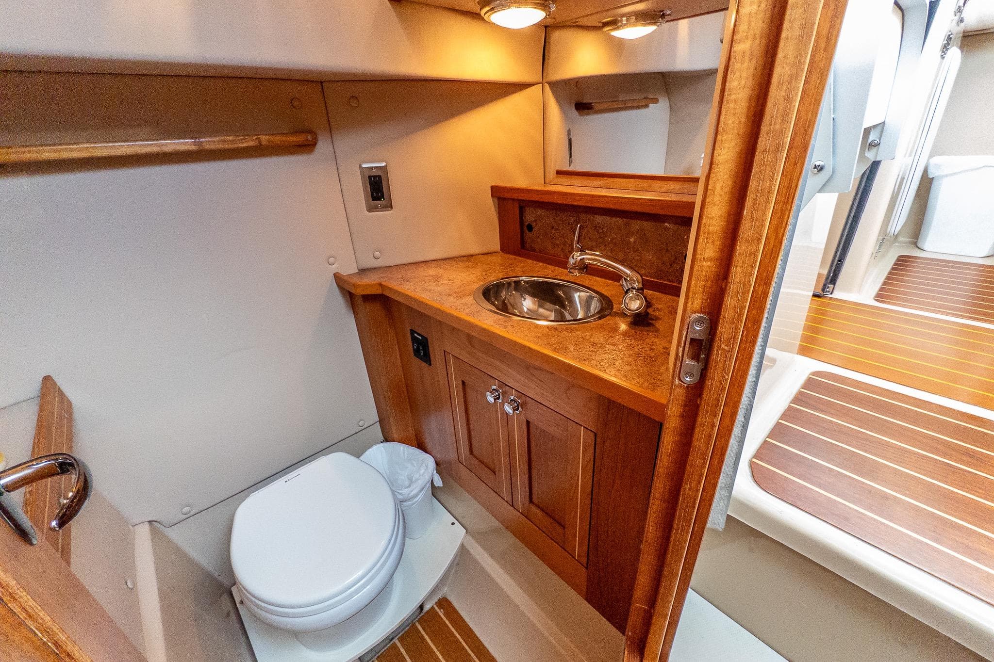 Aspen C90 2012 boat bathroom with wooden cabinetry and compact design.