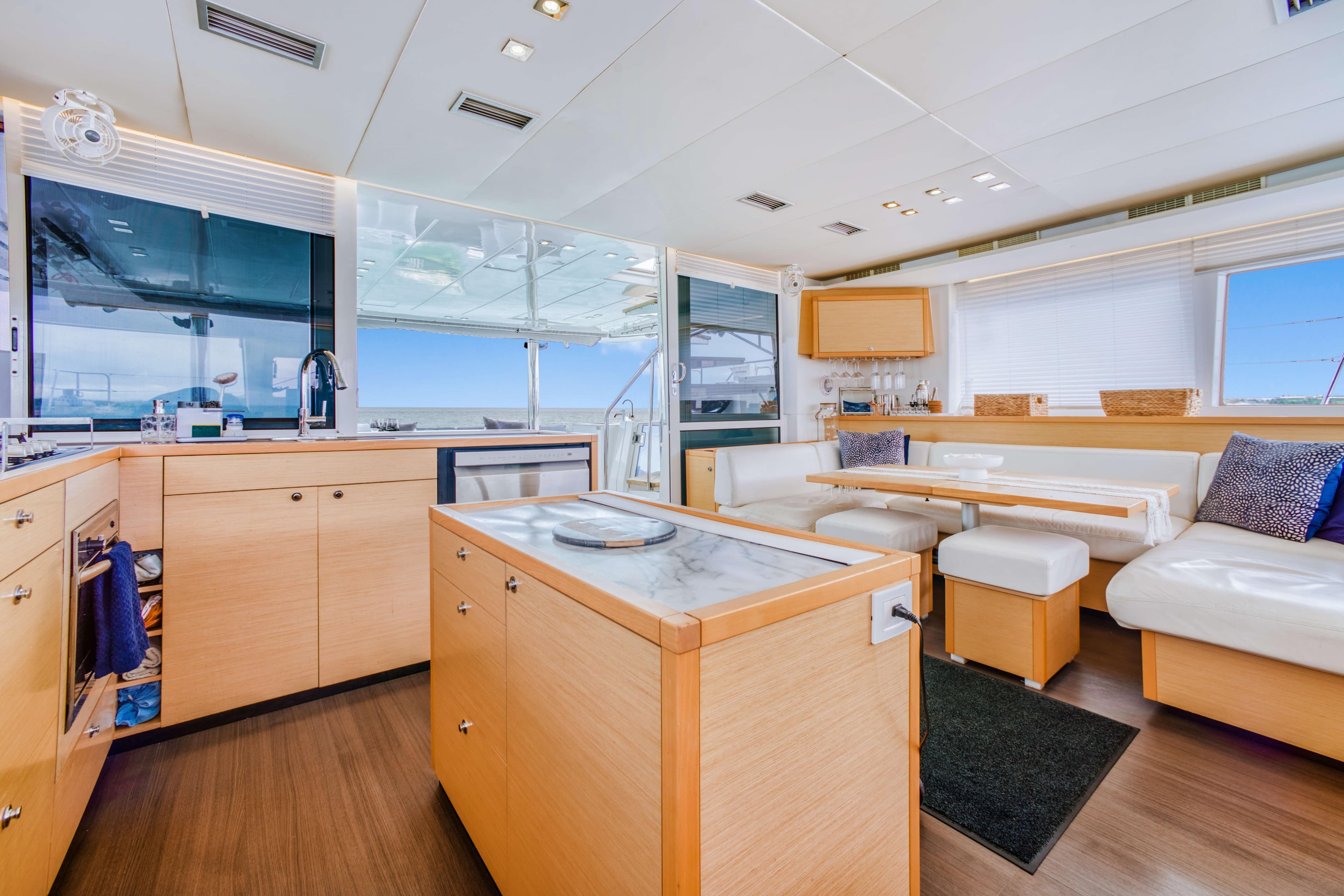 Luxurious interior of 2014 Lagoon 560 yacht with modern kitchen and seating area.