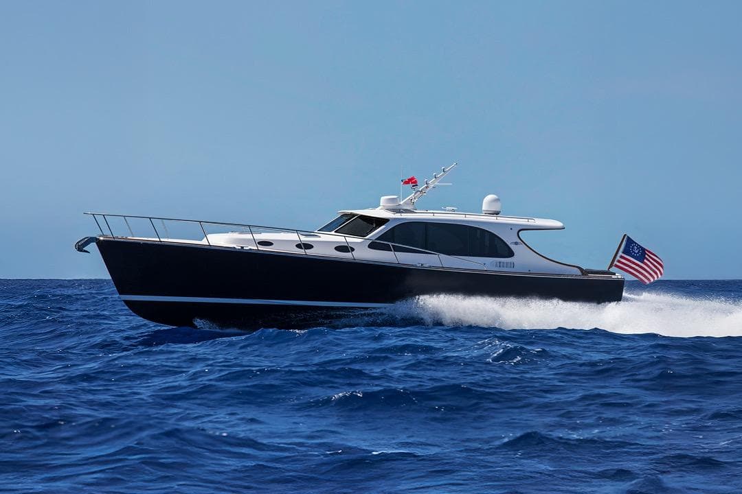 2026 Palm Beach Motor Yachts PB45 cruising on open sea with American flag.