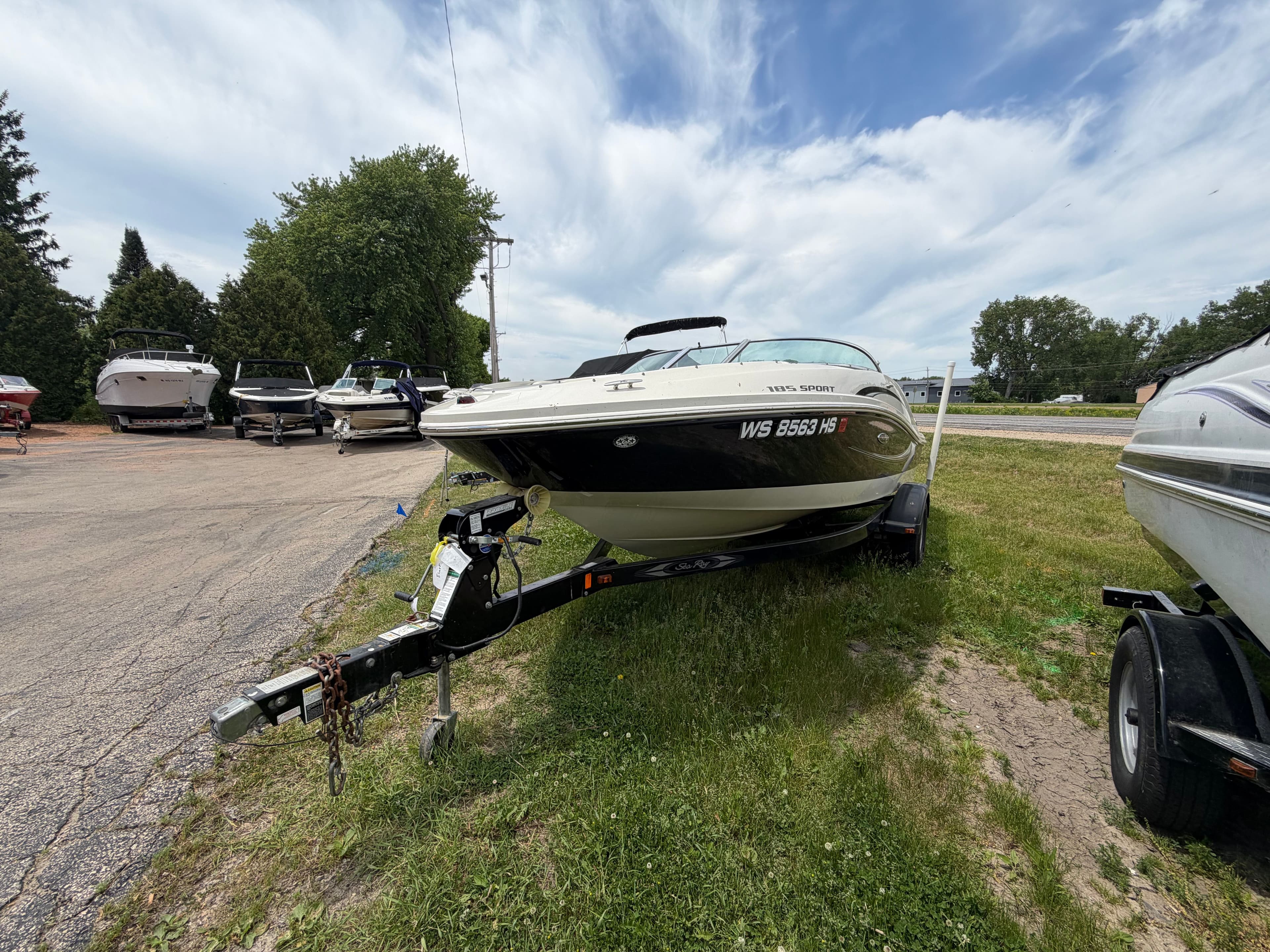 2010 Sea Ray 185 SP/SS boat on trailer outdoors.