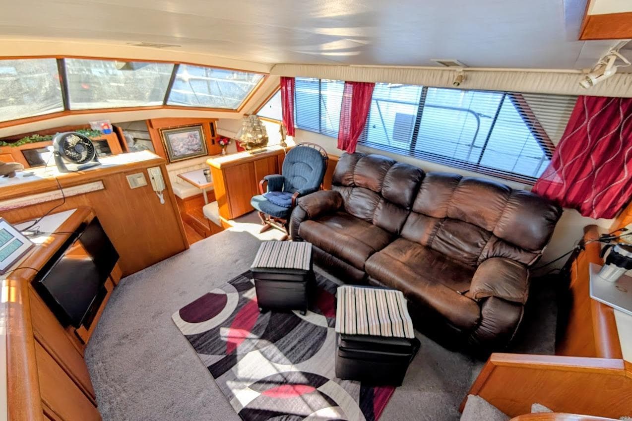 Luxurious interior of 1990 Carver 55 yacht with leather sofa and modern decor.