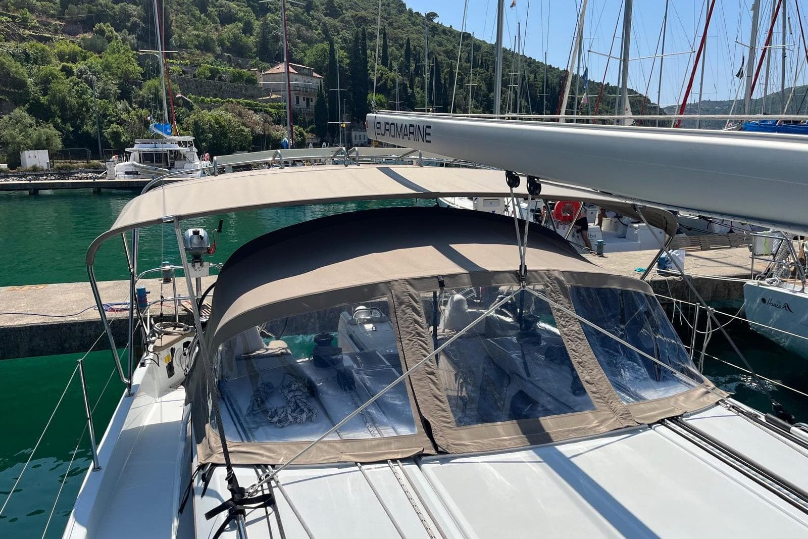 Jeanneau Sun Odyssey 410 sailboat docked, featuring a beige canopy, 2022 model.