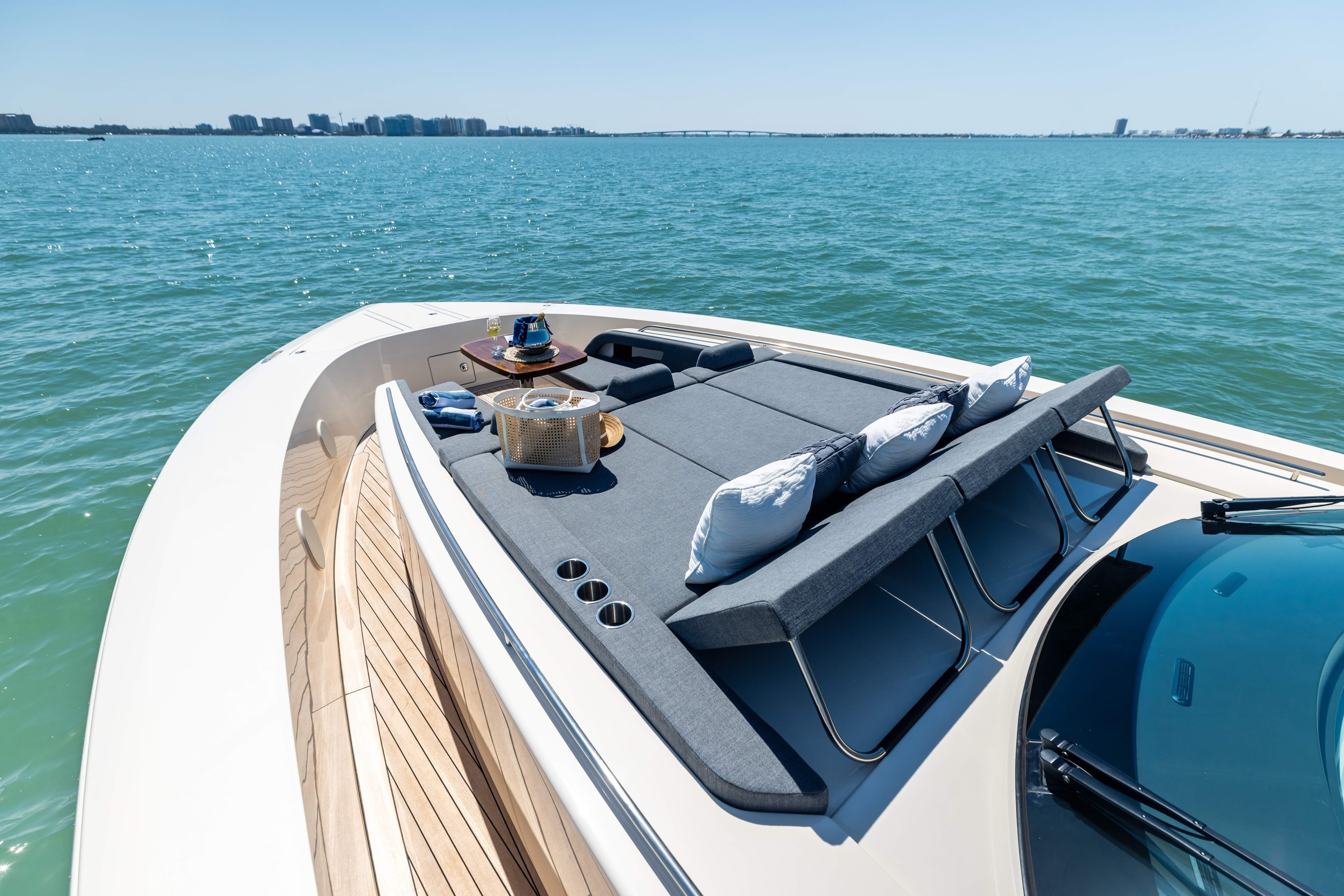 Luxurious 2026 Scout 670 LXS yacht with sunbathing deck on serene water.