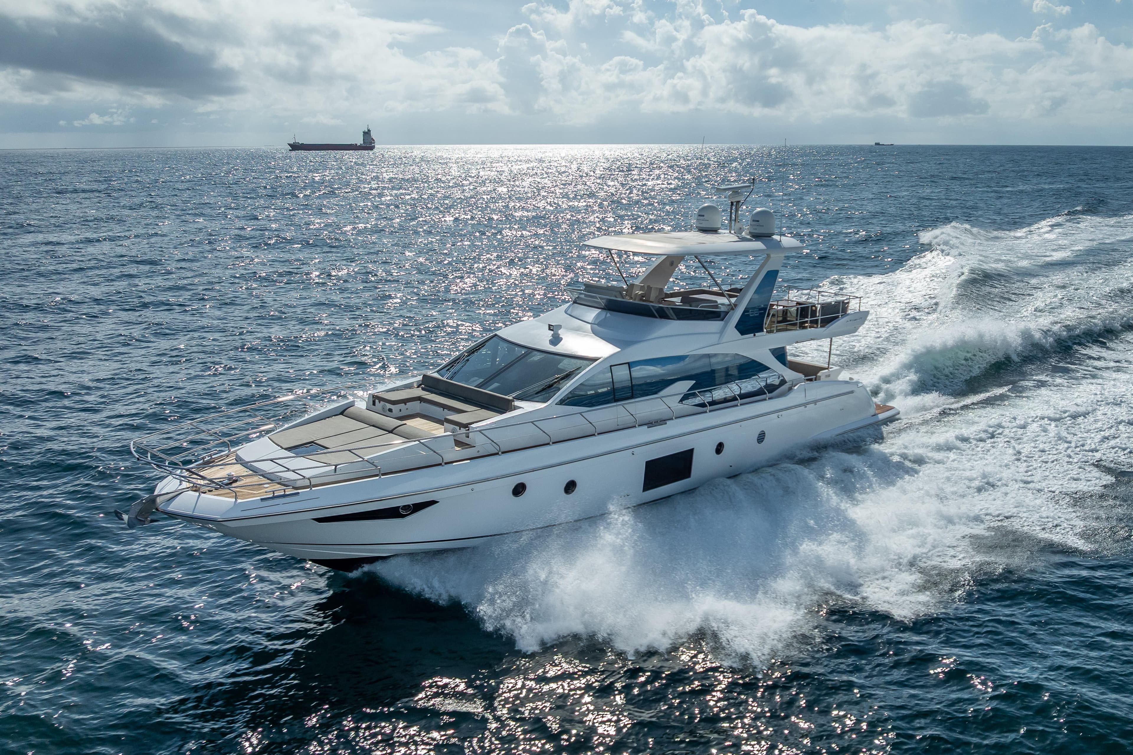 Luxurious 2019 Azimut 66 yacht cruising on open sea under clear skies.