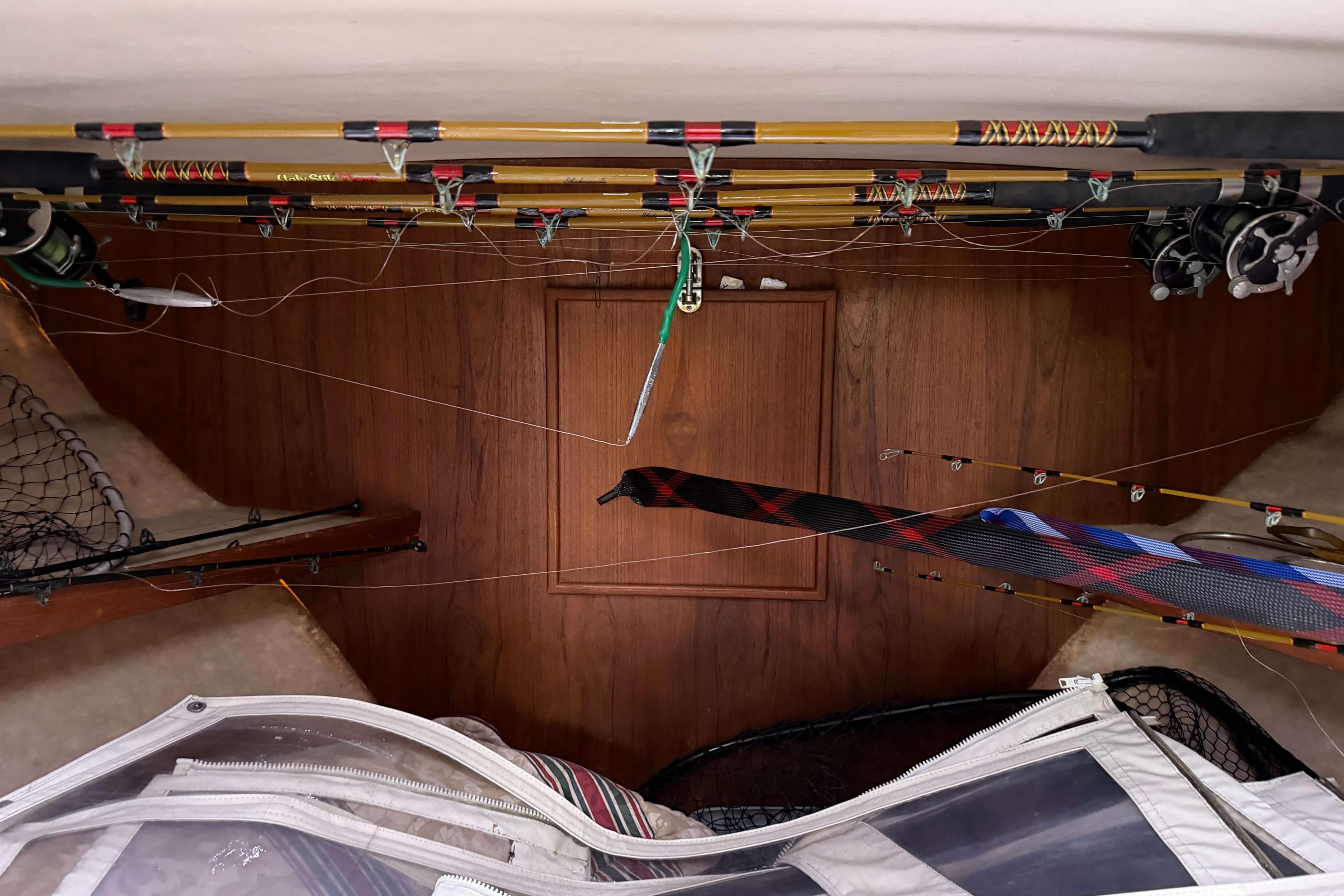 Interior of 1986 Henriques Yachts 35 Maine Coaster with fishing rods and gear storage.
