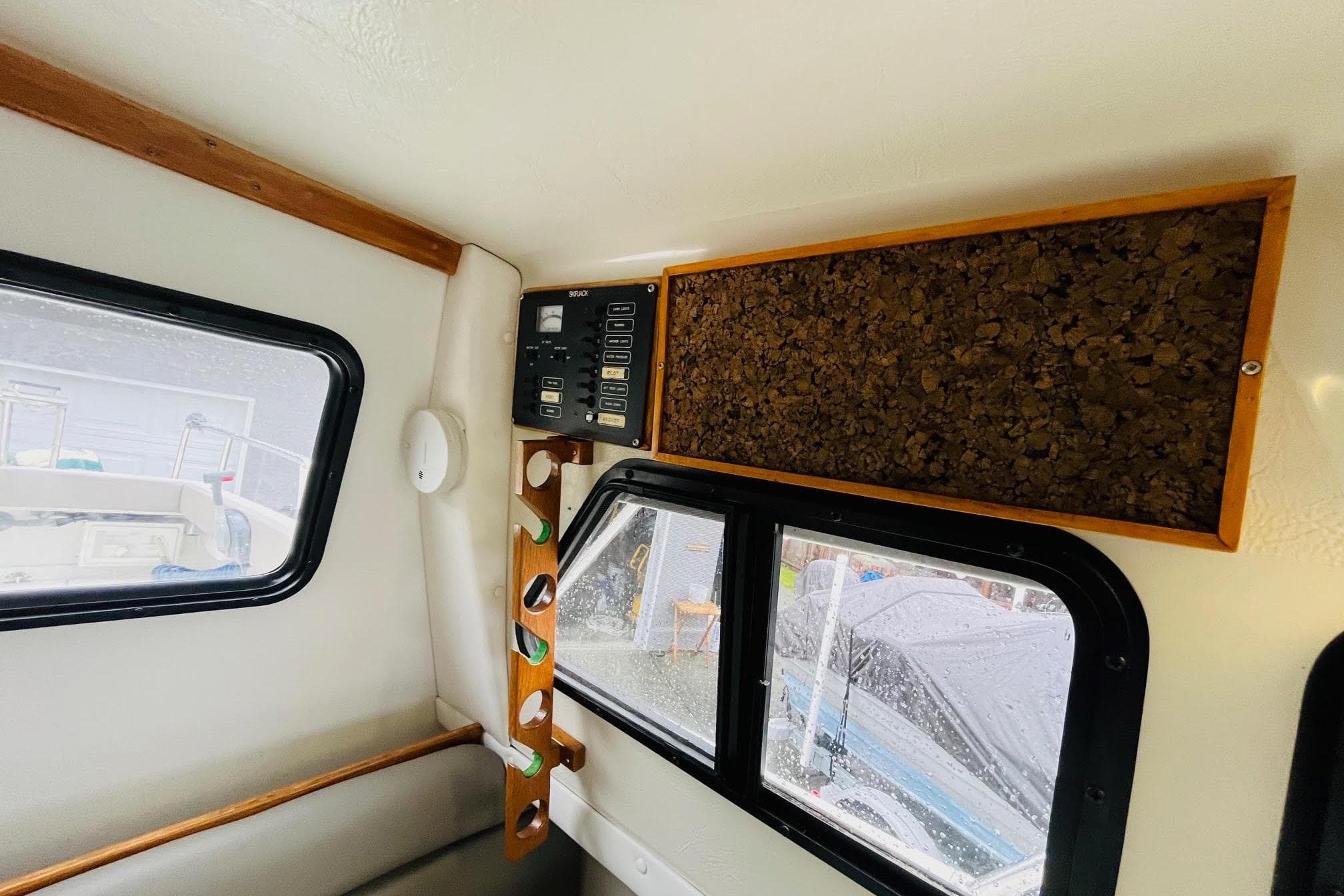Interior of 1997 Skipjack 262 Flybridge boat with control panel and windows.