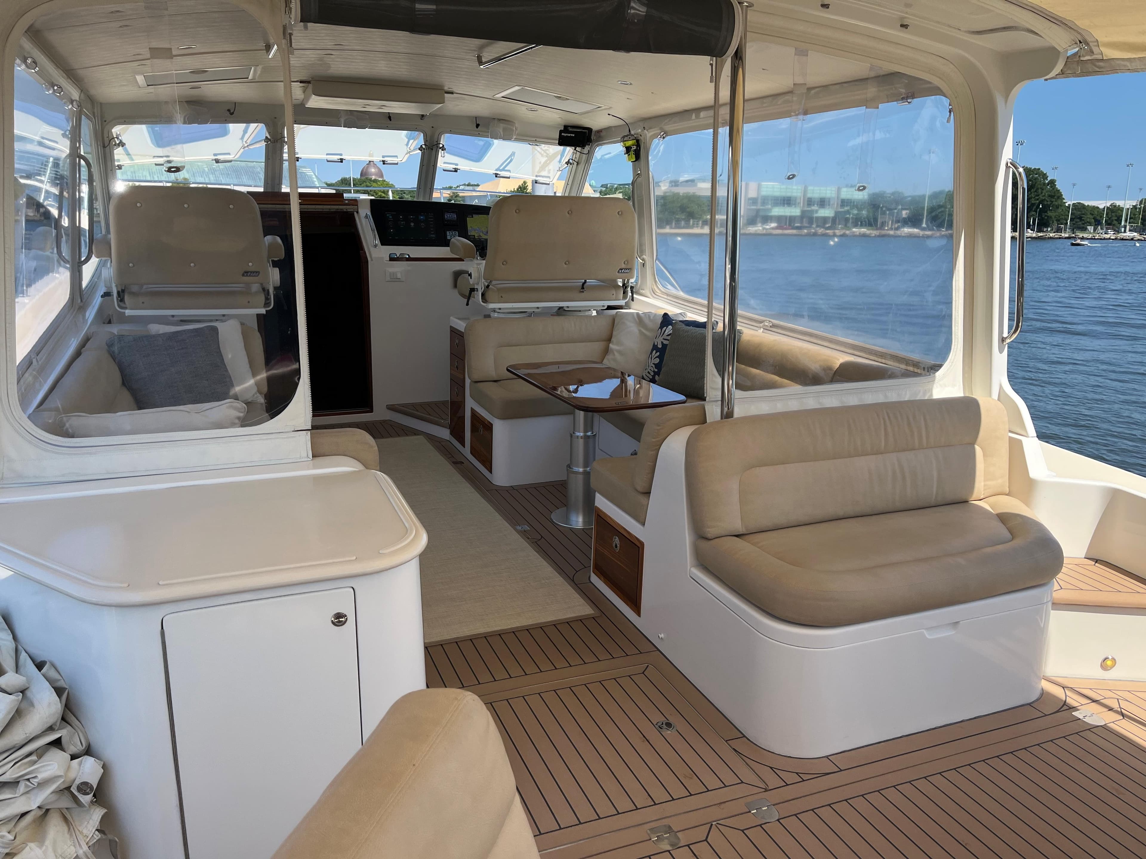Luxurious 2016 MJM 50z yacht interior with beige seating and scenic water view.