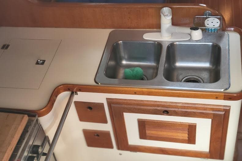 1988 Freedom Yachts FREEDOM 36 kitchen with dual sinks and wooden cabinetry.