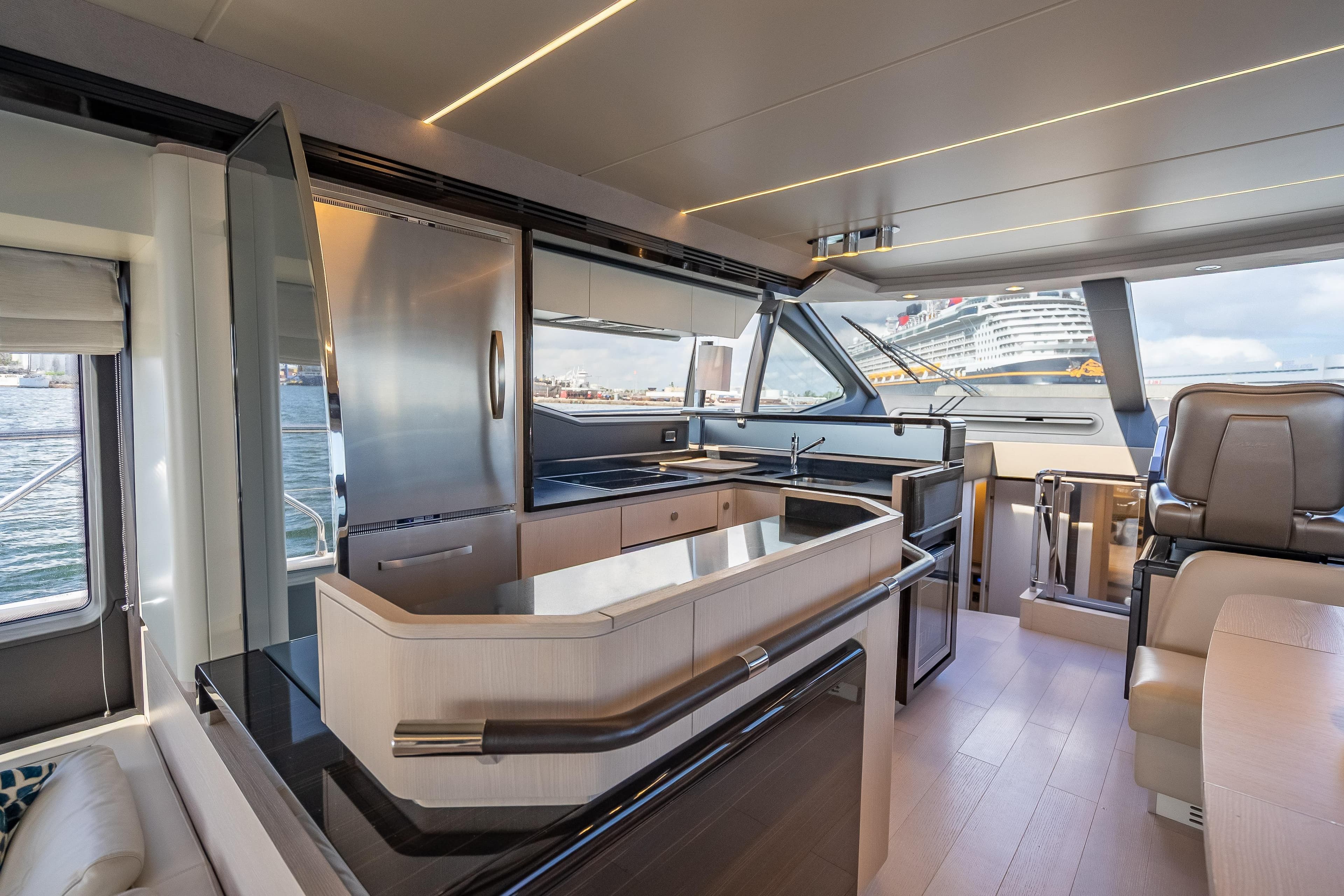 Luxurious interior of 2019 Azimut 66 yacht with modern kitchen and panoramic windows.