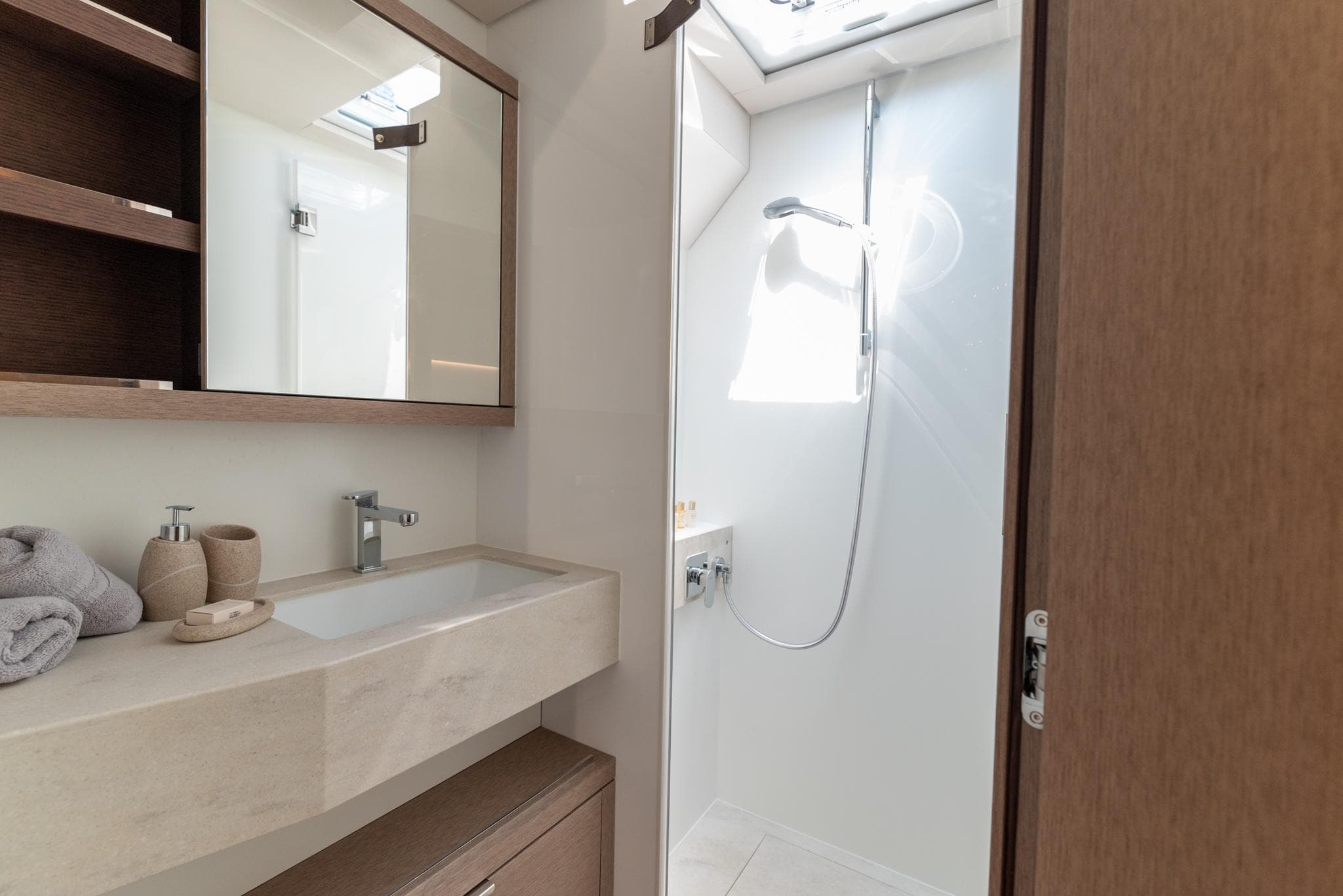 Modern bathroom in 2024 Lagoon SIXTY 5 yacht with sleek fixtures and natural lighting.