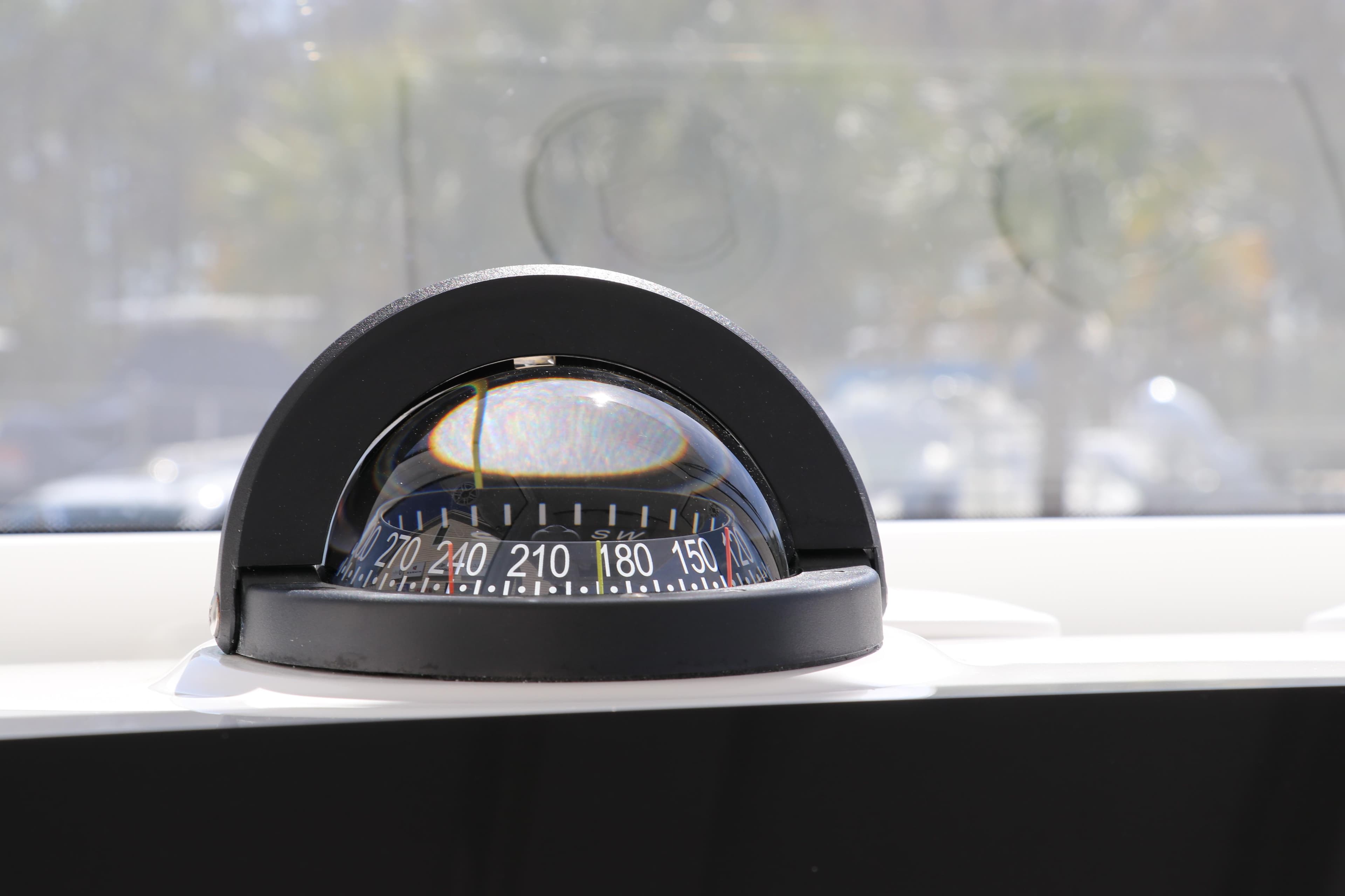 Compass on Edgewater 325CC boat, 2025 model, displaying navigation degrees.