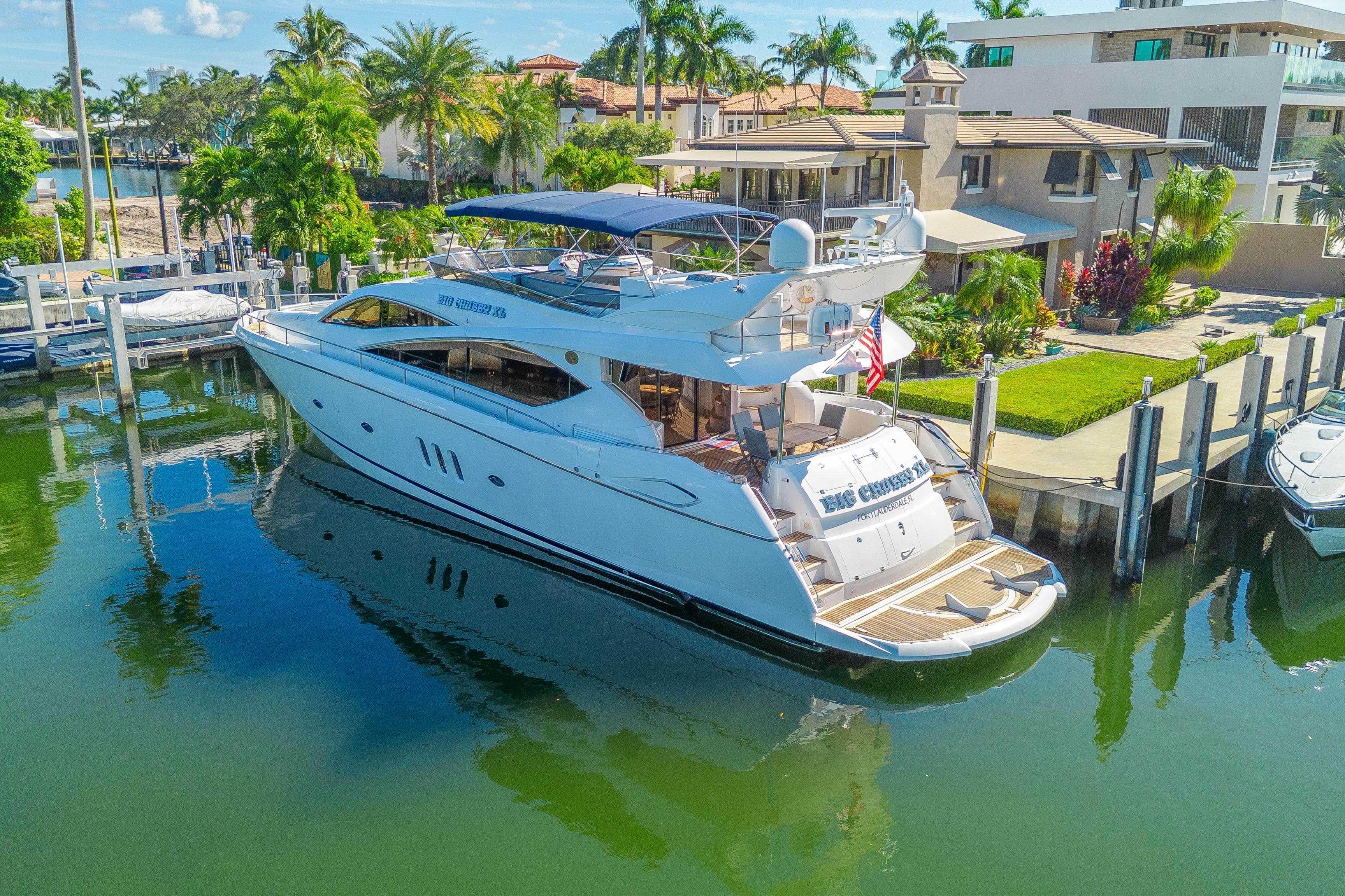 2006 Sunseeker 75 Yacht docked in a scenic waterfront setting.