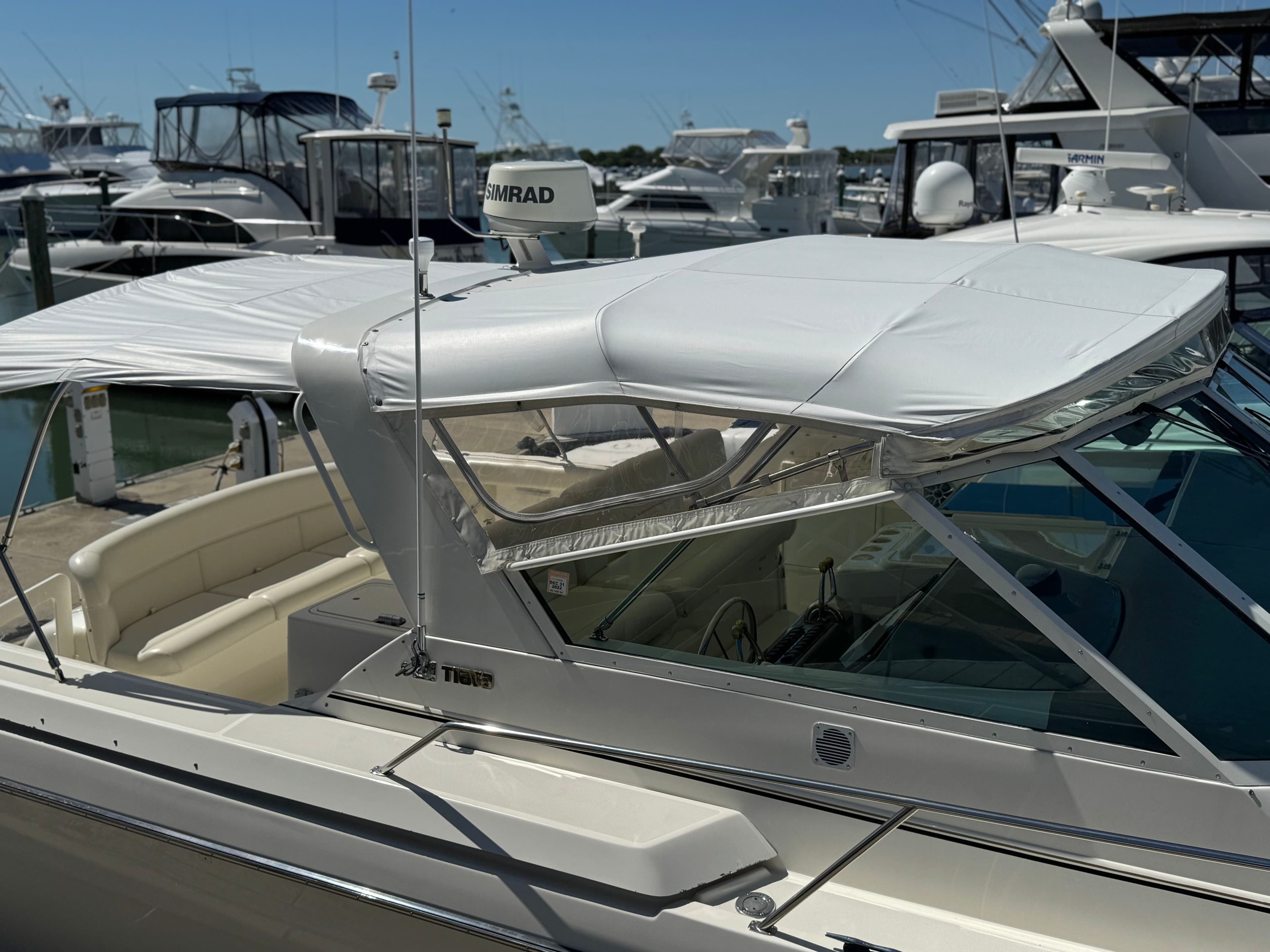 1996 Tiara Yachts 3500 Express at dock, white canopy.