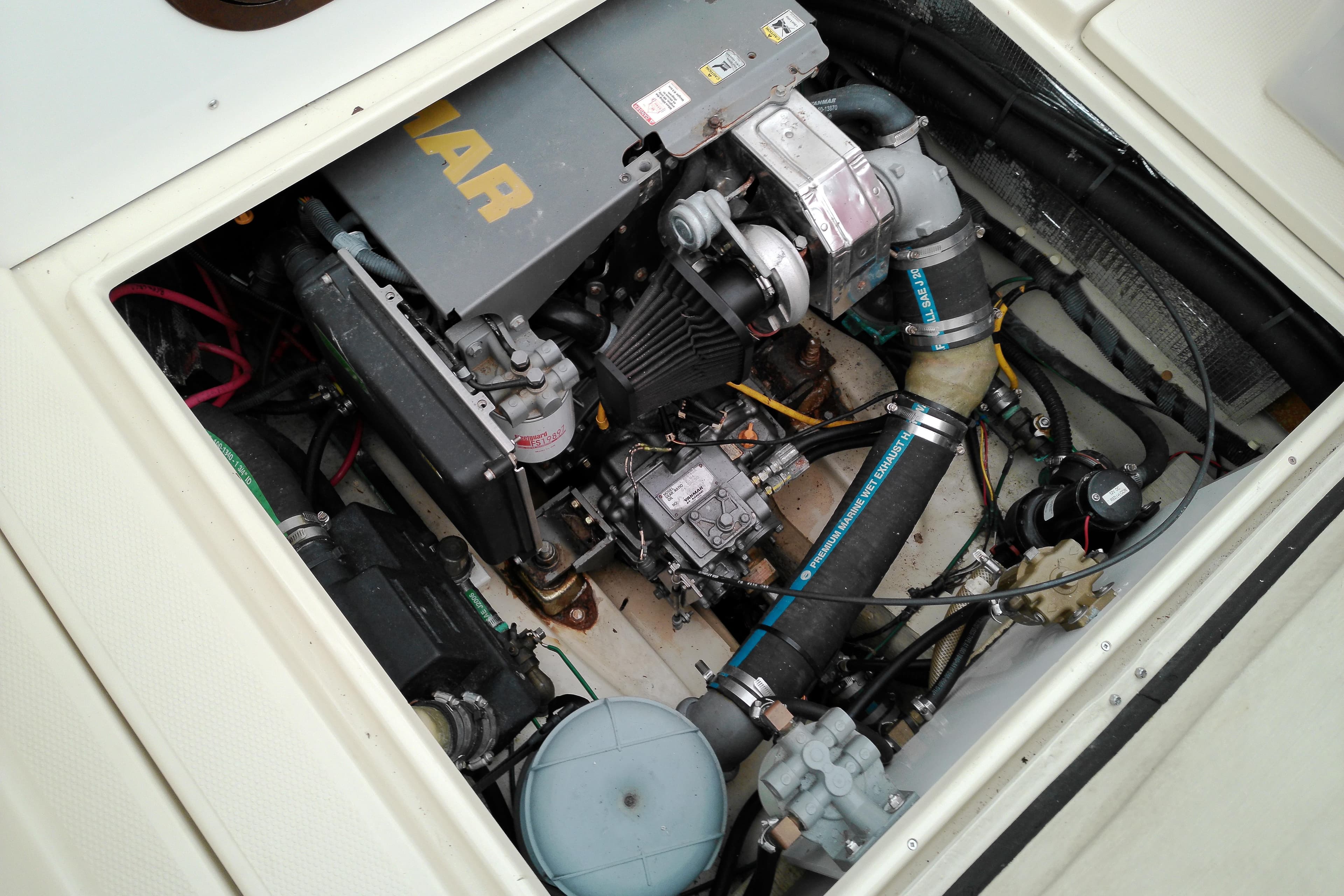 Engine compartment of a 2010 Ranger Tugs R-25 boat, showcasing mechanical components.