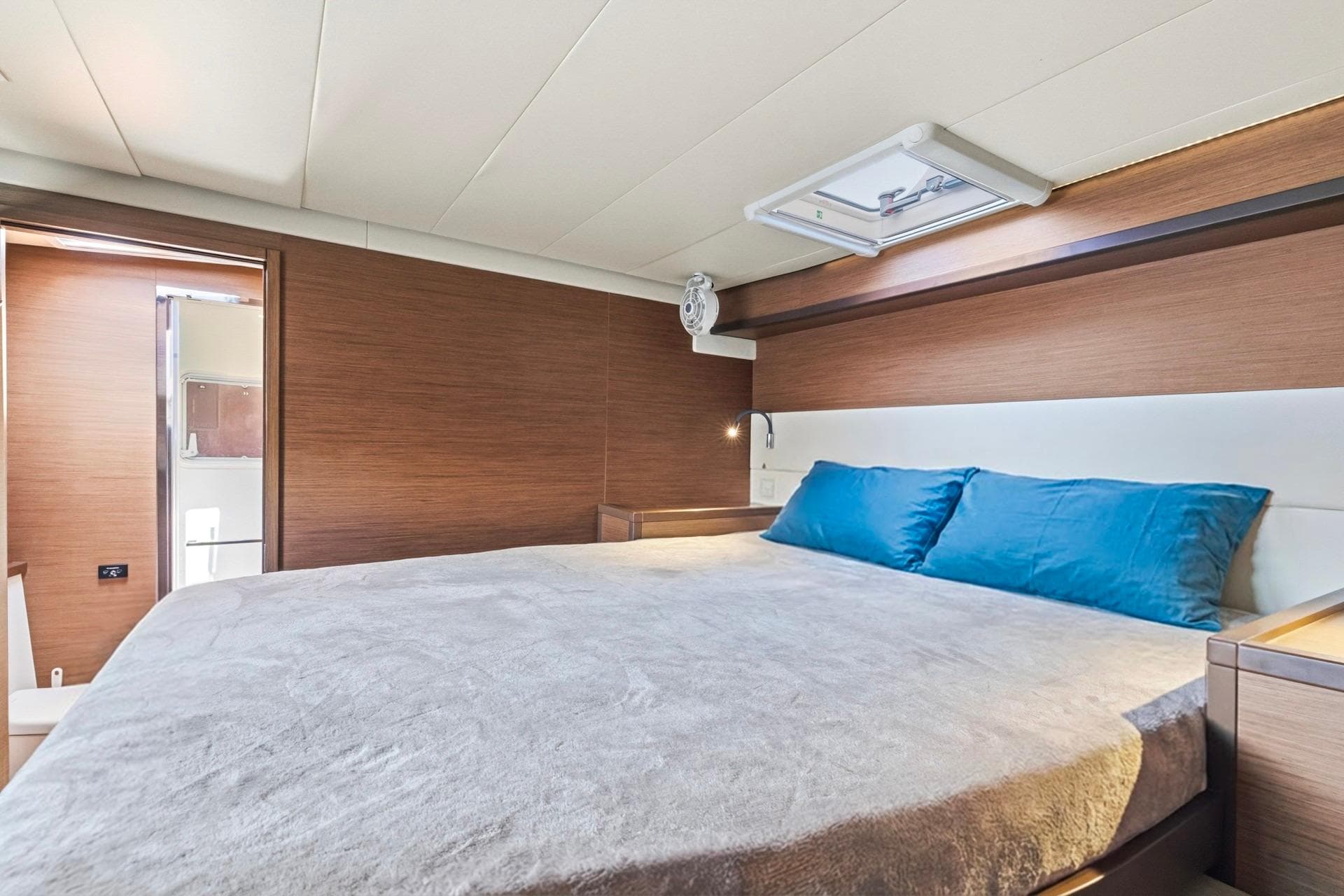 Luxurious bedroom interior of 2021 Lagoon 52 F yacht with modern design.