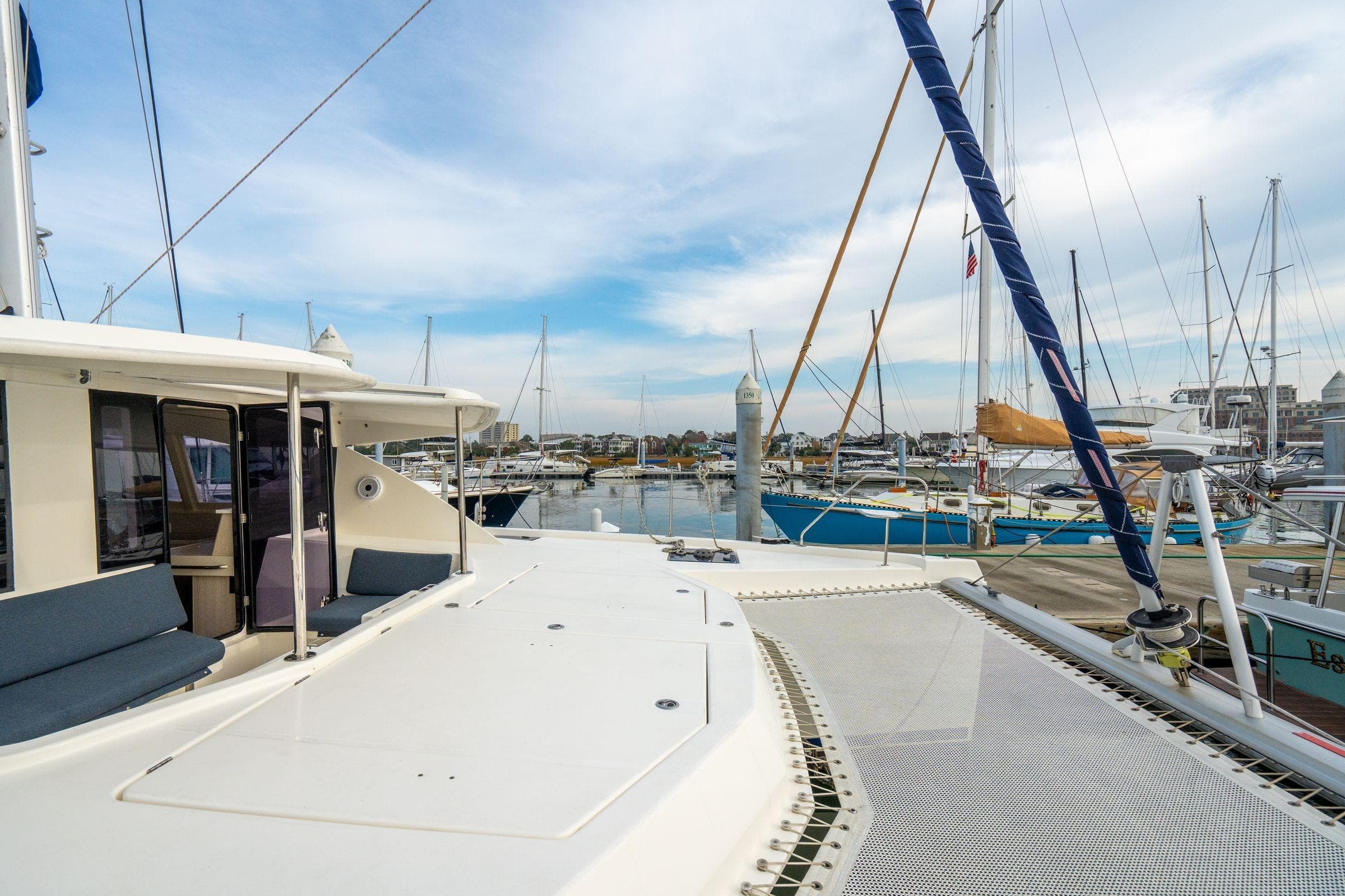 Leopard 48 catamaran docked at marina, showcasing spacious deck and modern design.