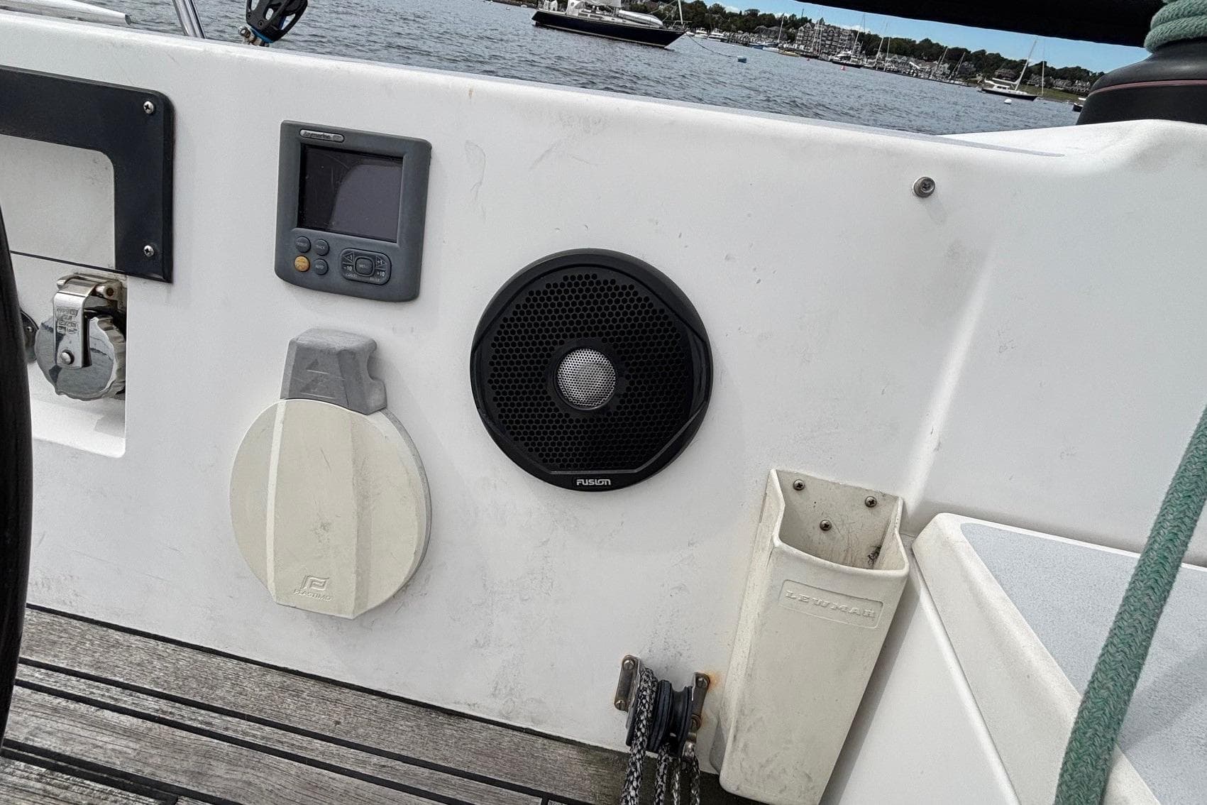 2008 J Boats J/122 cockpit with navigation equipment and speaker, docked by the water.