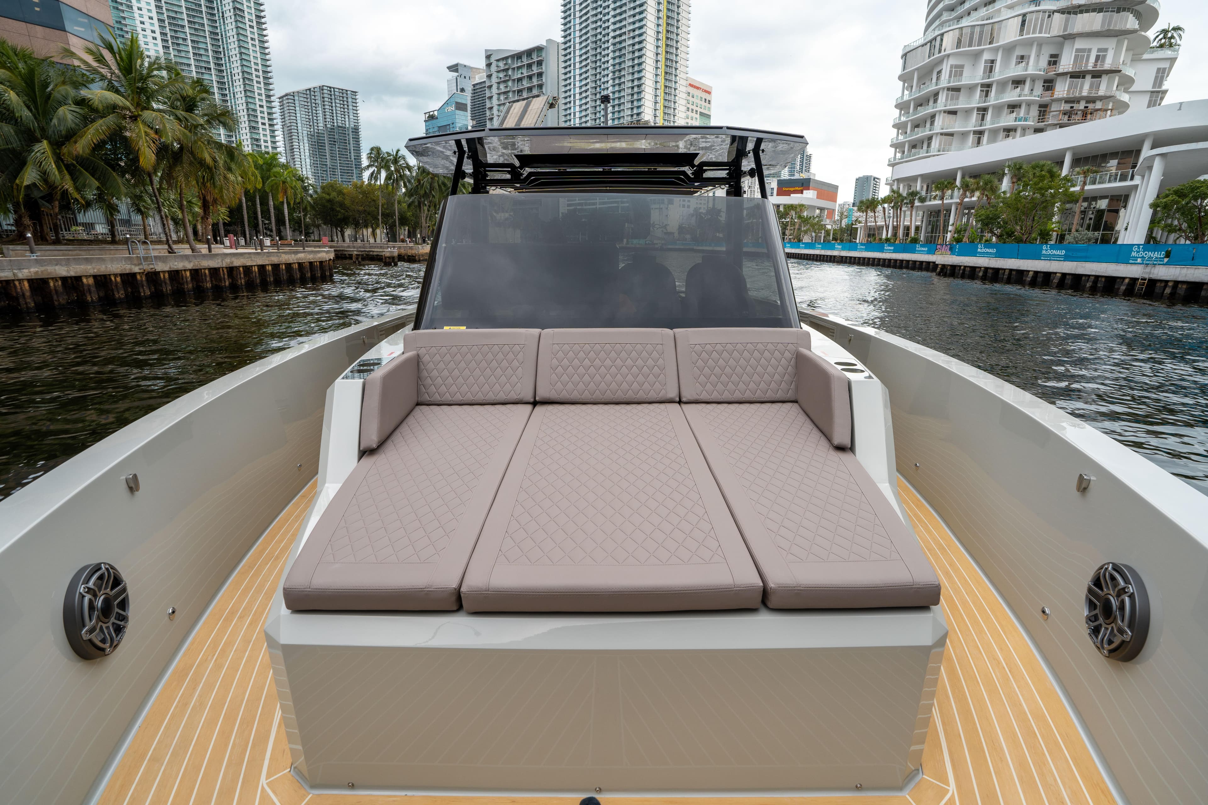 2025 De Antonio Yachts D42 Open with spacious deck and luxurious seating in urban marina.