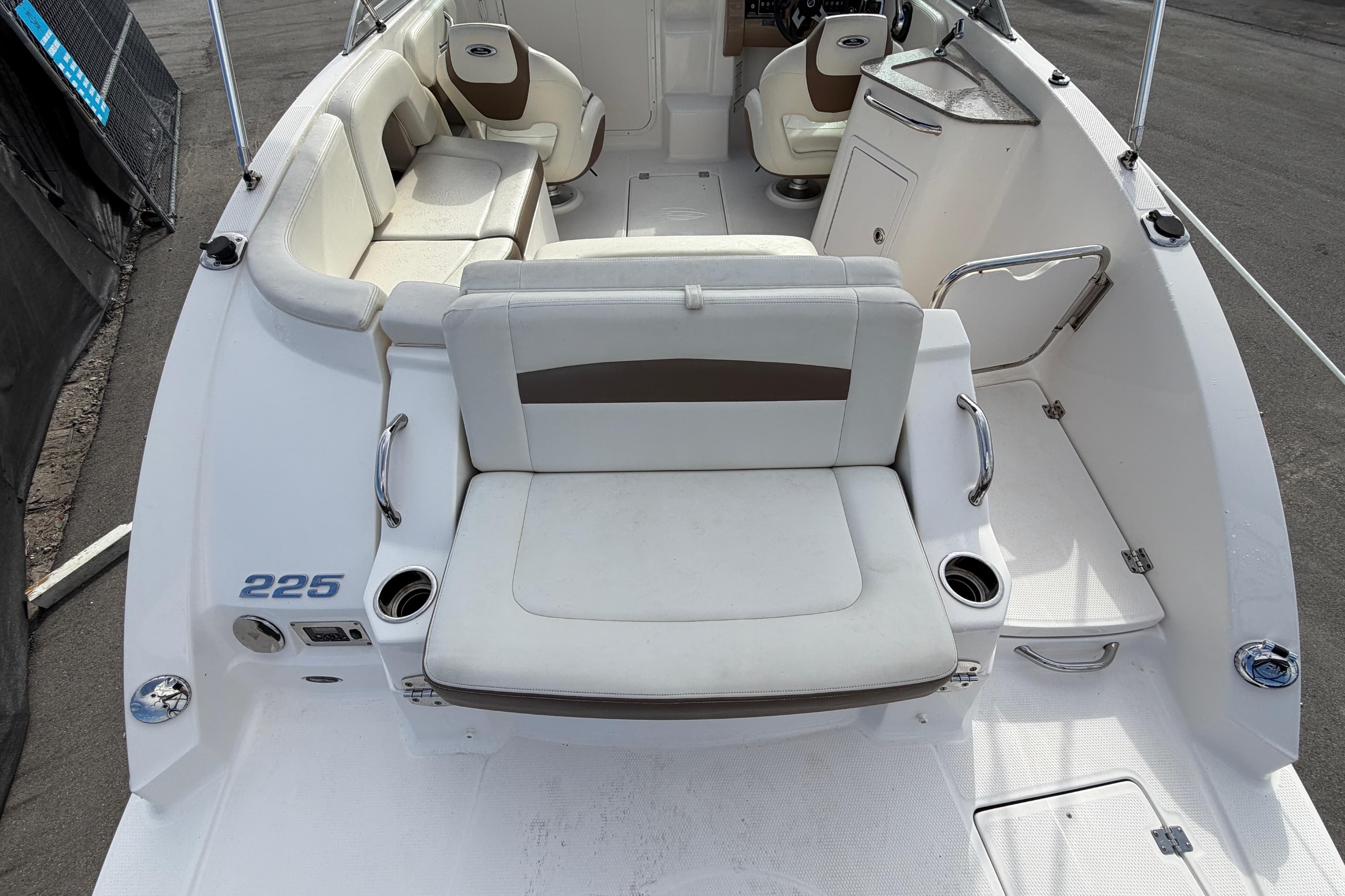 2014 Chaparral 225 SSi boat interior with white seating and cup holders.