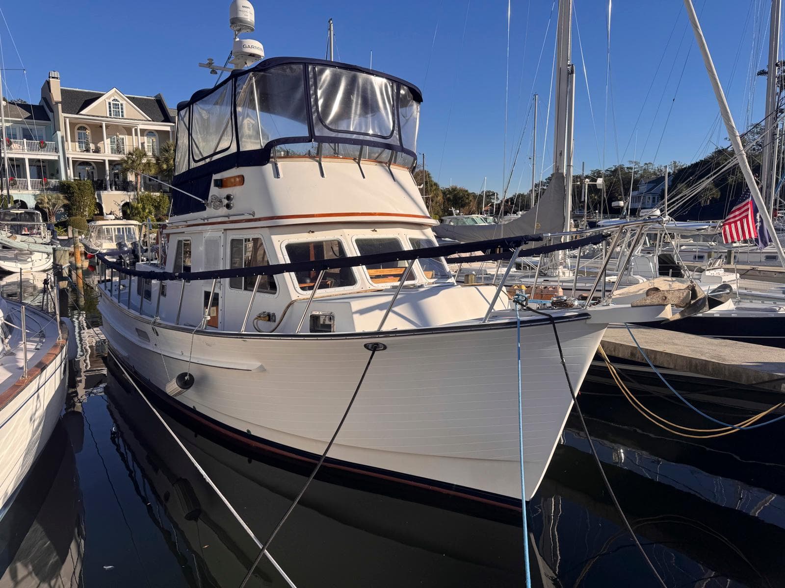 1999 Monk 36 Trawler docked at marina, clear sky background.