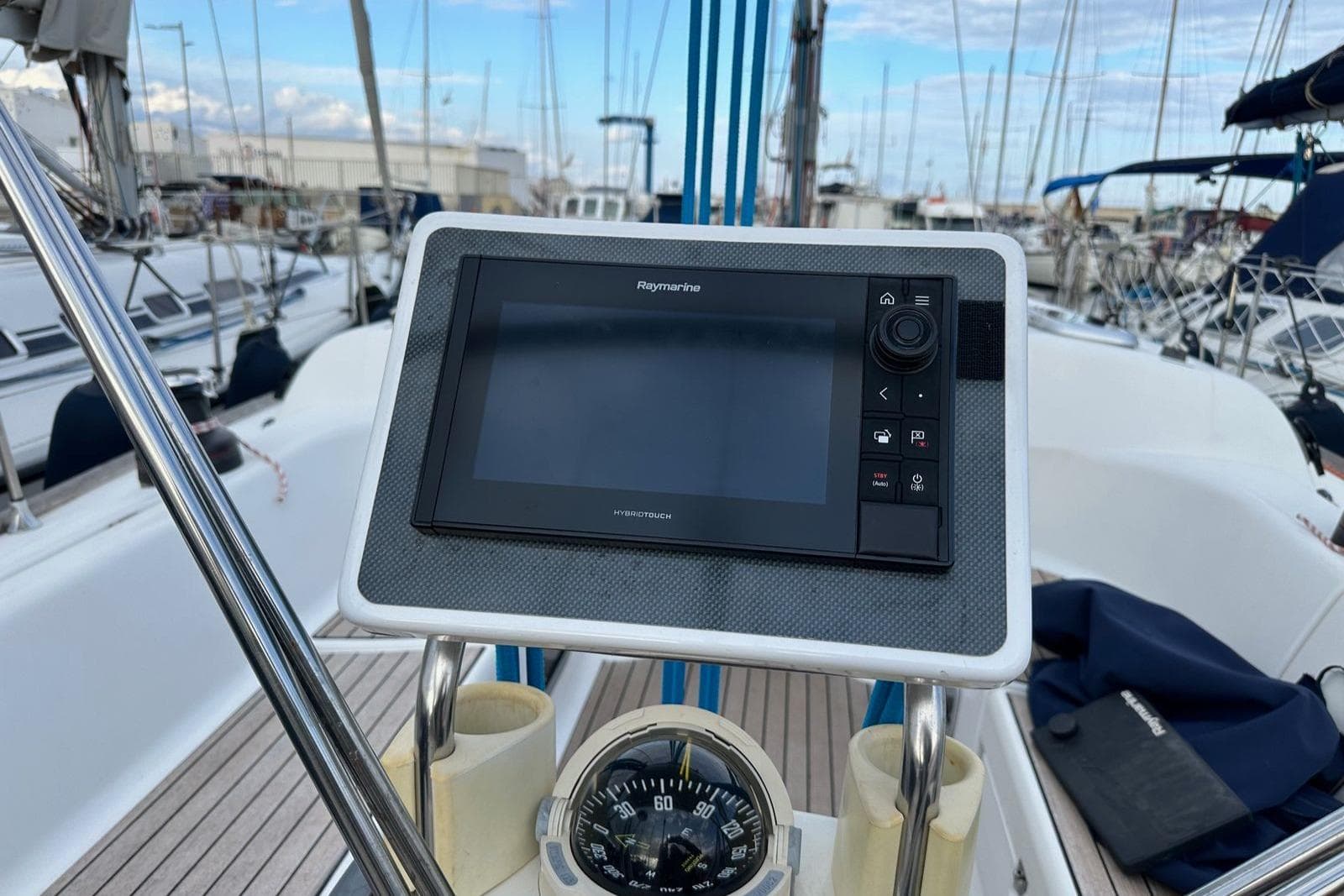 Cockpit of 2004 Dufour 40 sailboat with Raymarine navigation display and compass.