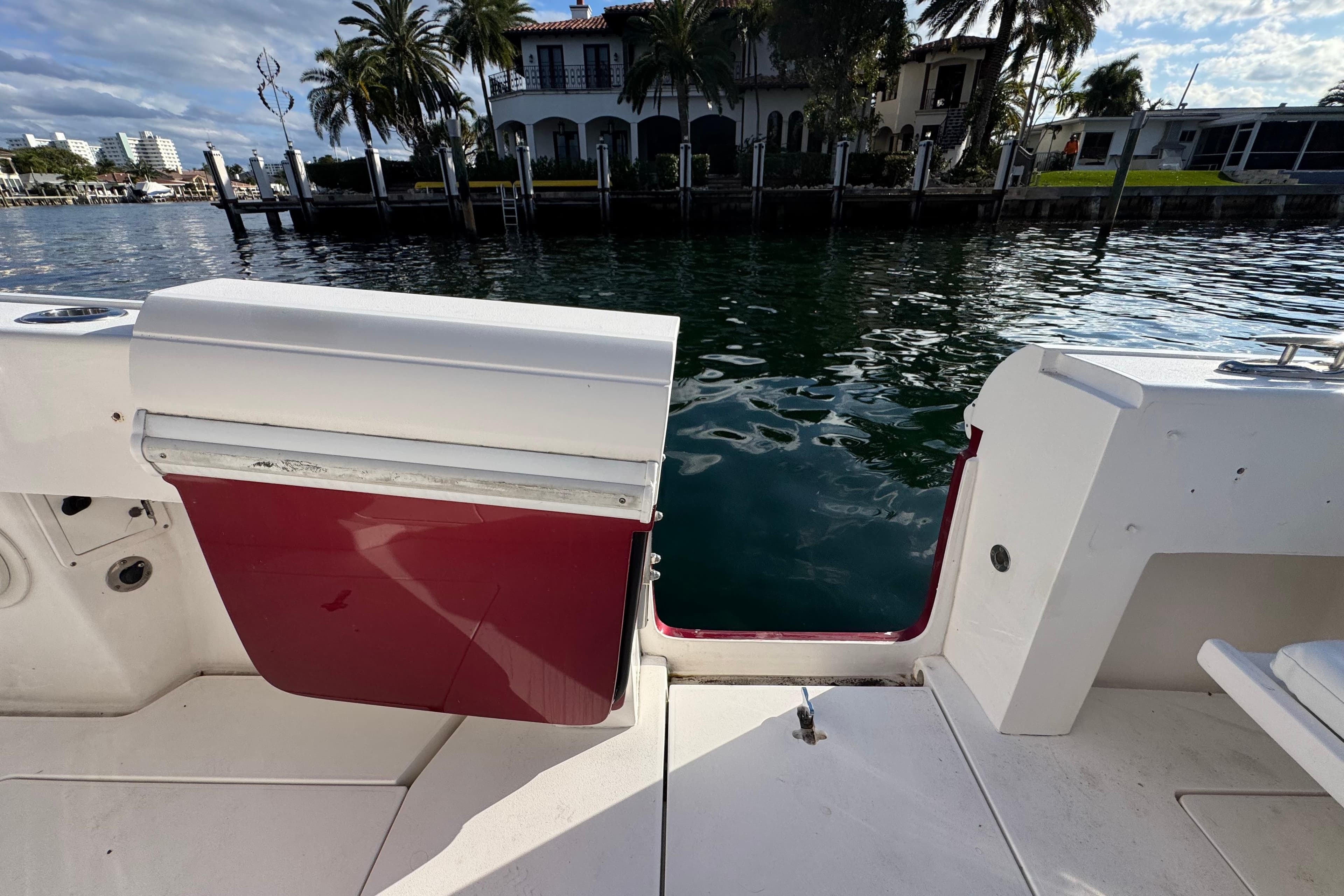 2017 Intrepid 375 Center Console boat with open transom door, dockside view.