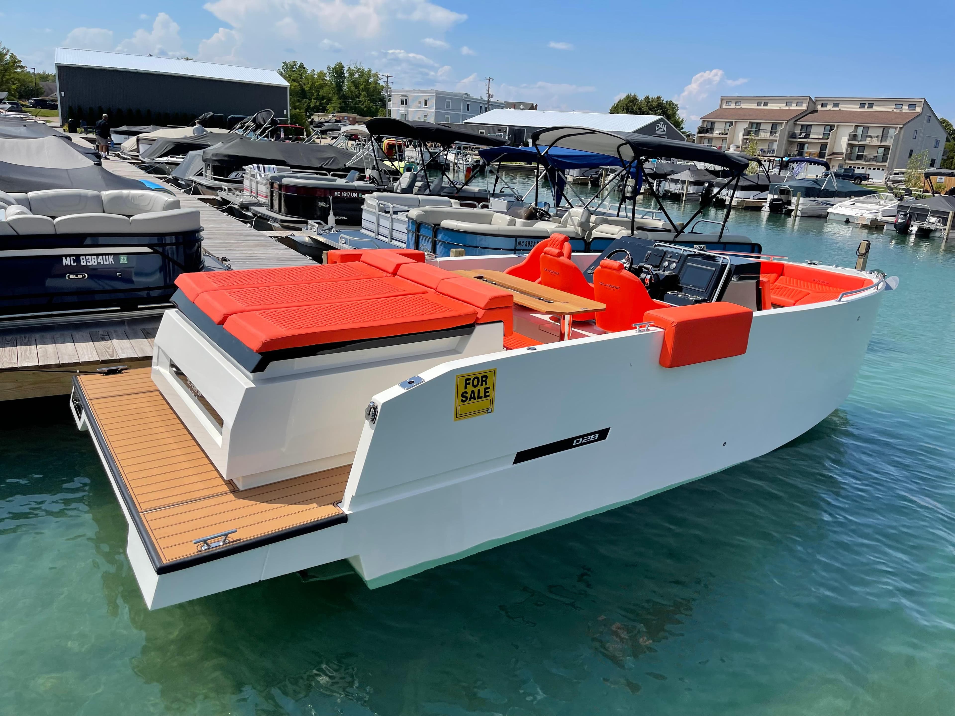 2020 De Antonio Yachts D 28 for sale at marina, red seating, white hull.