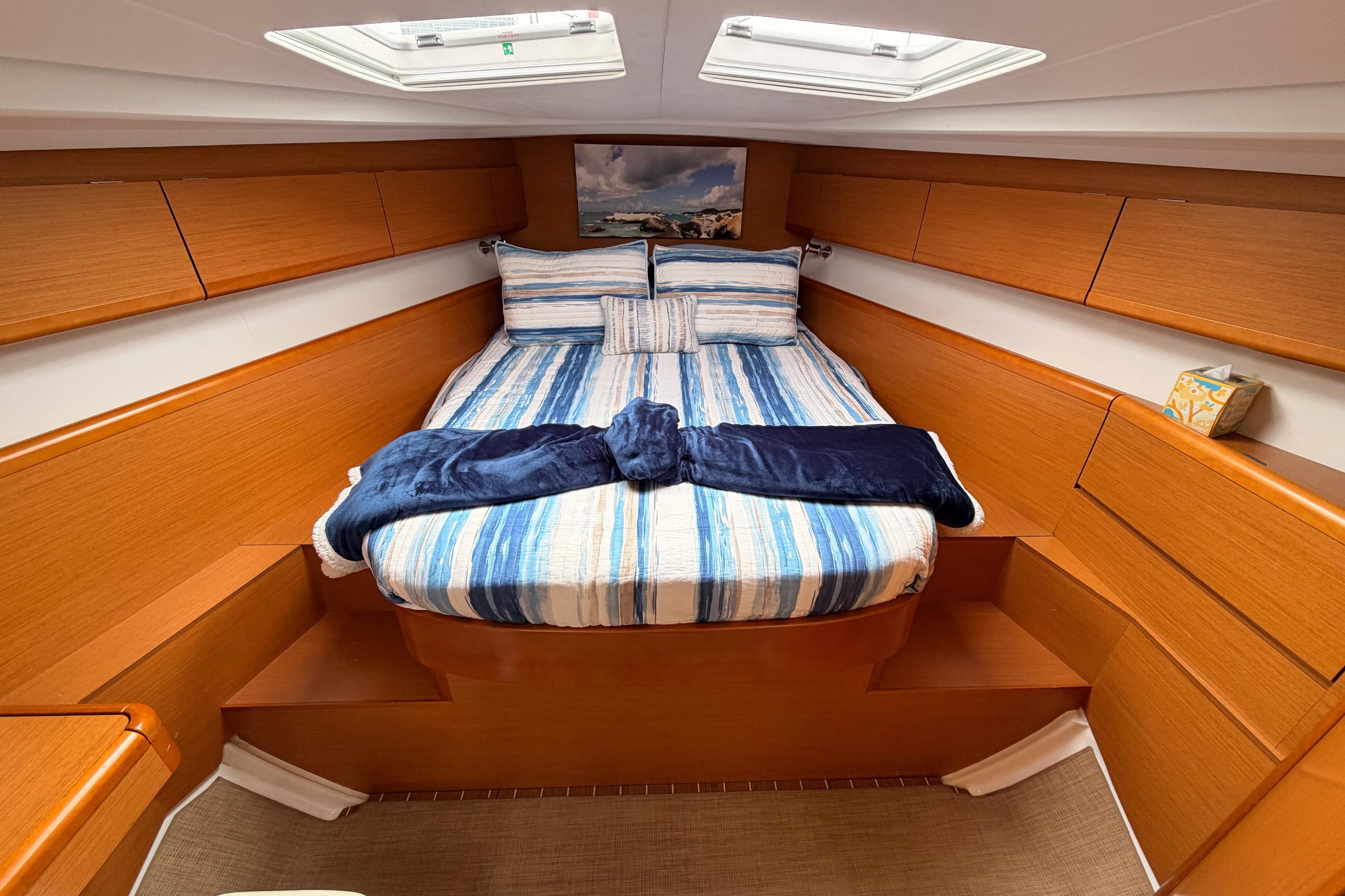 Luxurious cabin interior of 2014 Jeanneau Sun Odyssey 50 DS sailboat with cozy bedding.
