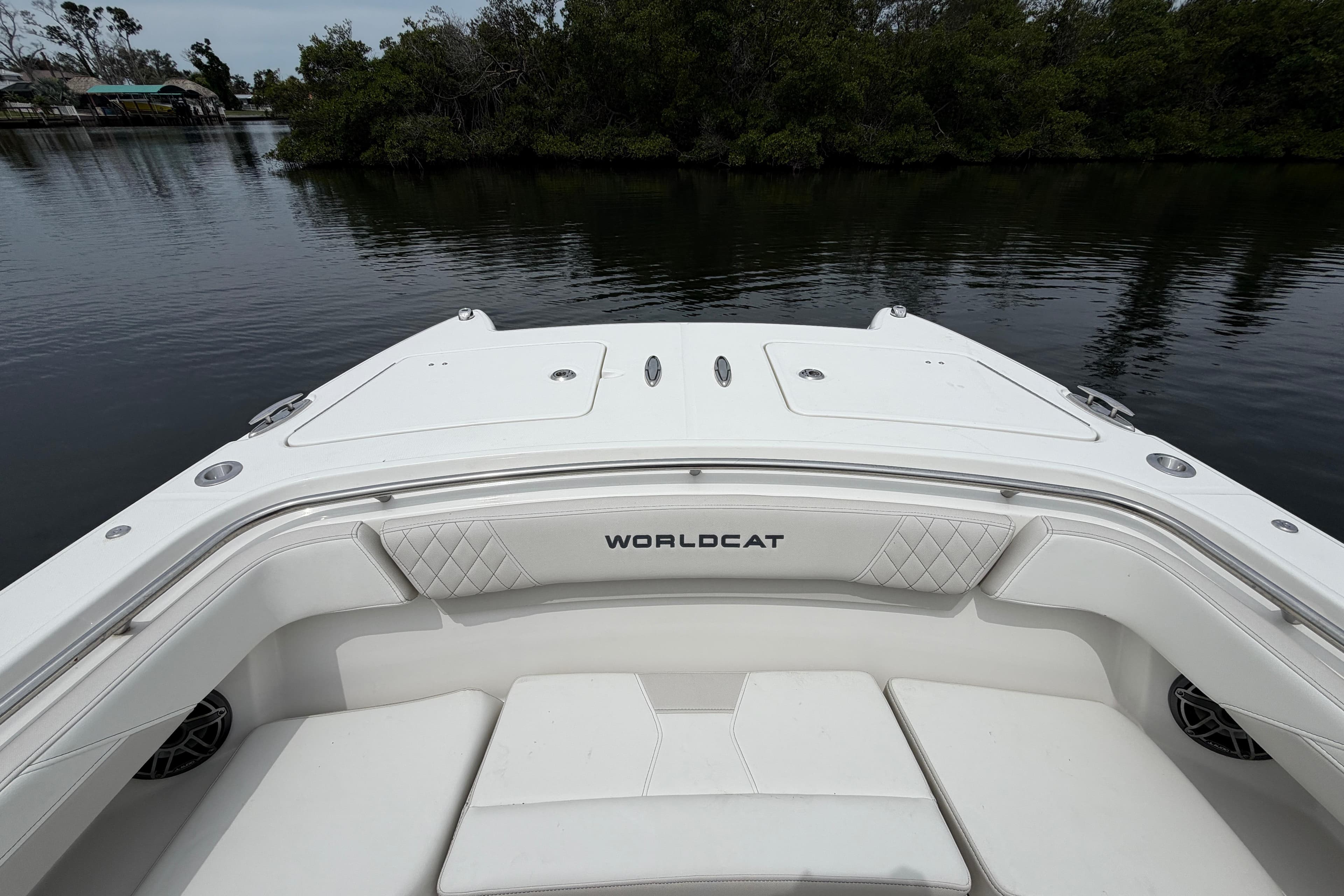 2026 World Cat 280 CC-X boat interior with white seating, on calm water.