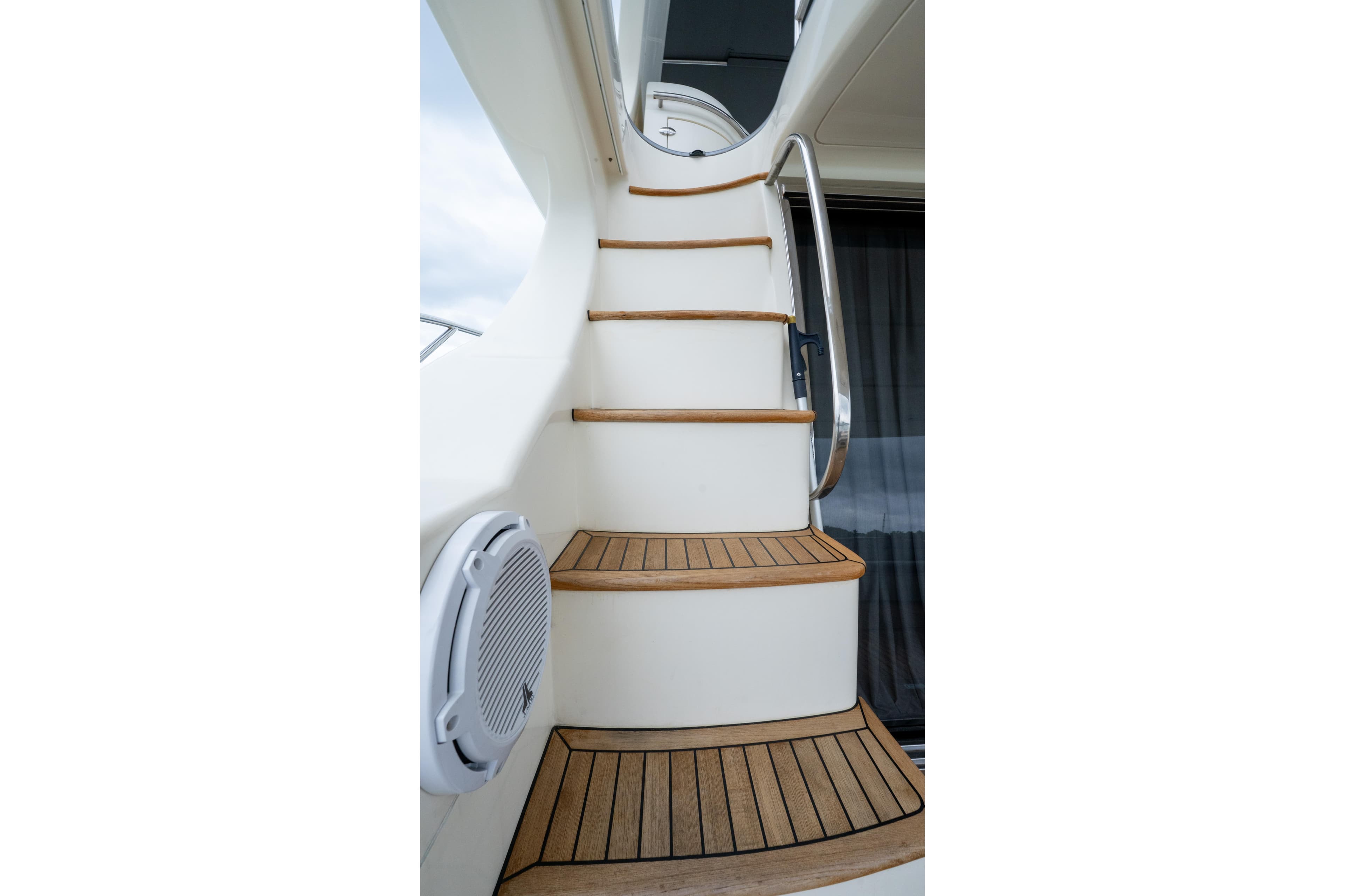 Staircase on 2008 Azimut 62E yacht with wooden steps and metal railing.