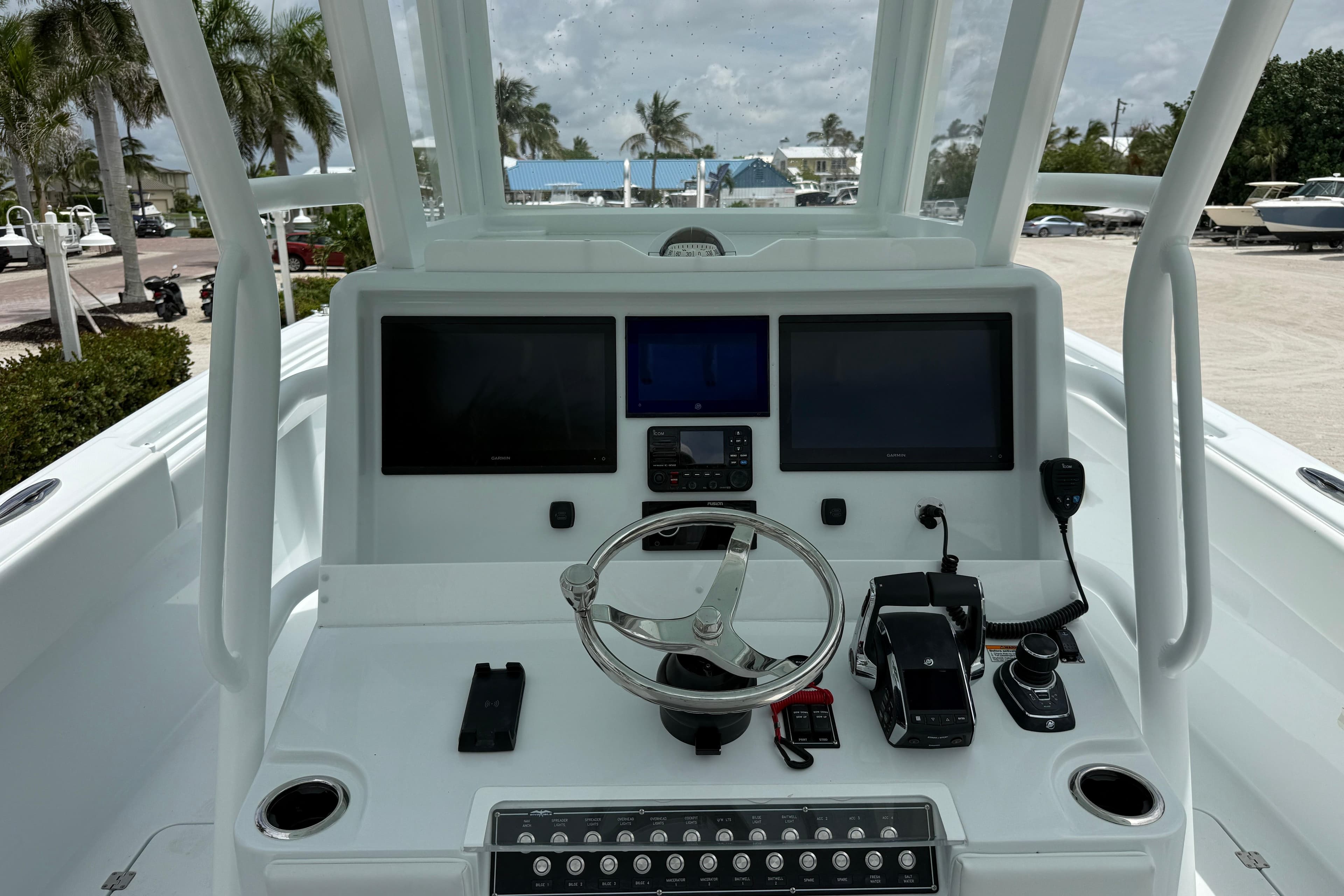 Cockpit of 2026 Invincible 33 Catamaran with modern navigation equipment and steering wheel.