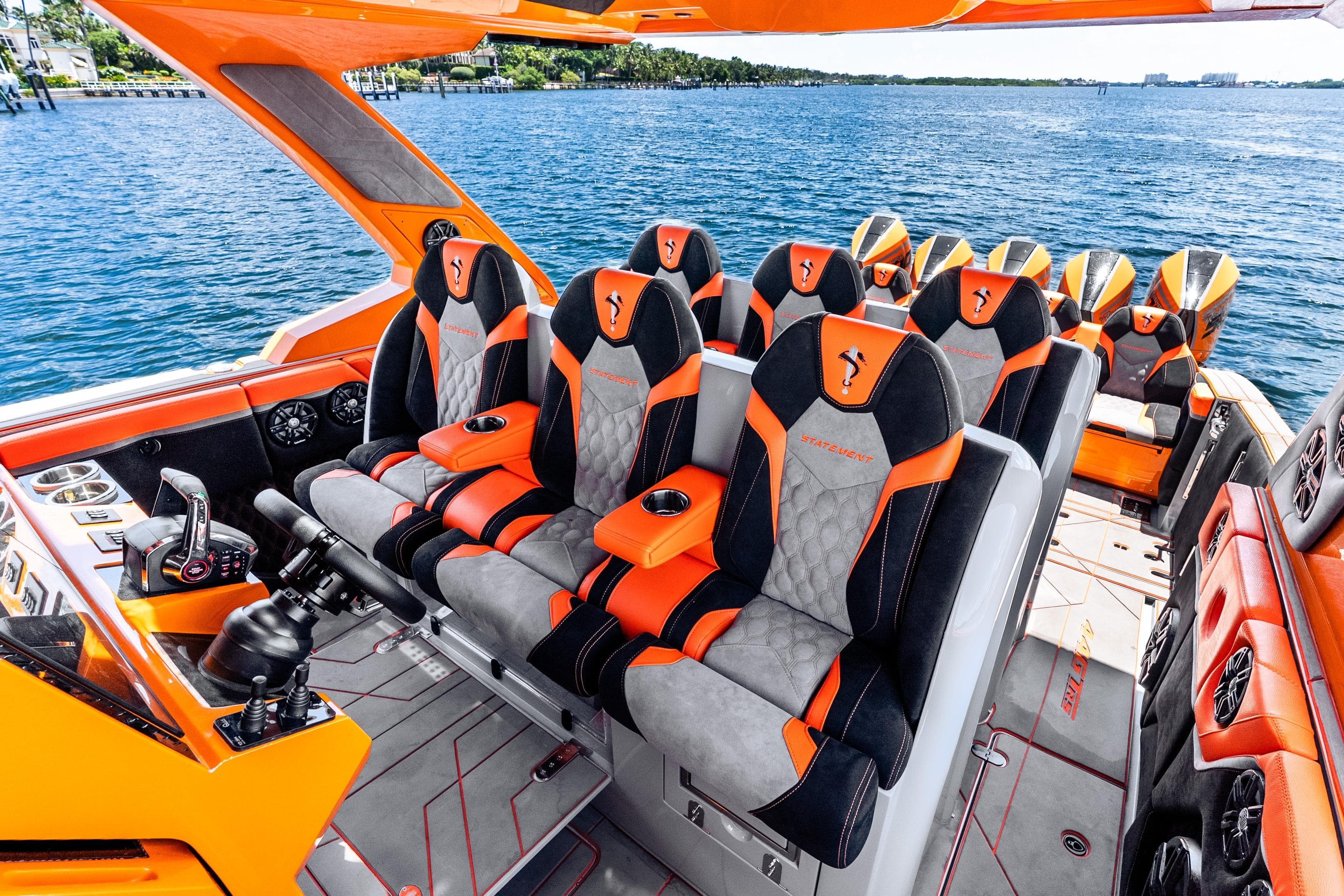Luxurious 2025 Statement 44 GRTS boat interior with orange and black seating, overlooking the ocean.