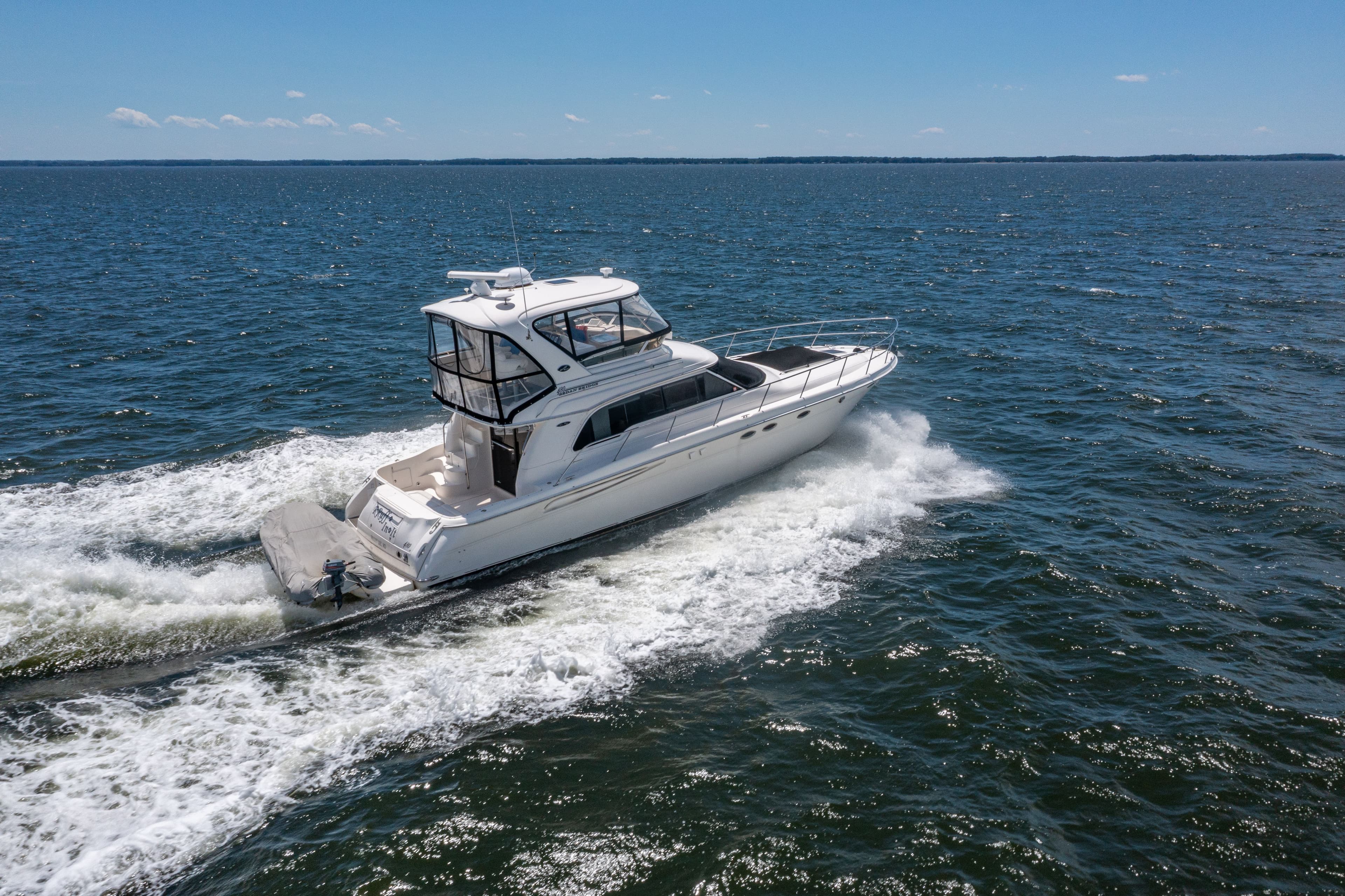 2004 Sea Ray 480 Sedan Bridge cruising on open water.