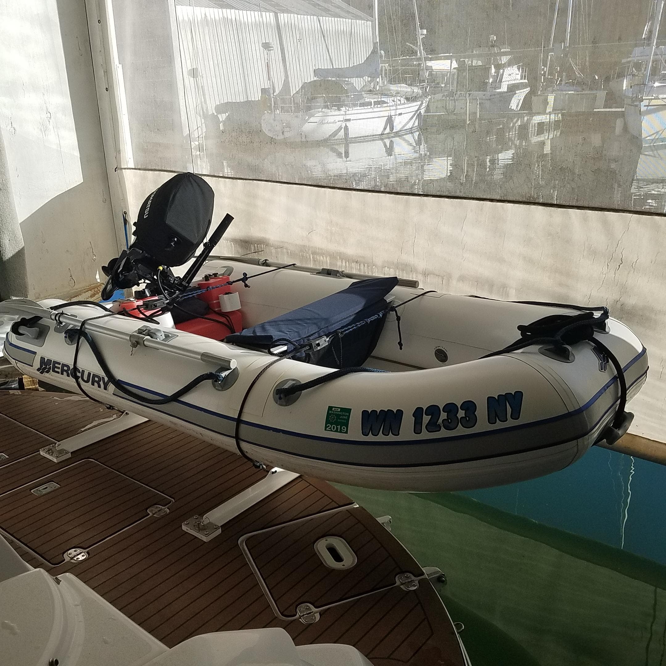 Inflatable boat with Mercury motor docked on a Four Winns 350, 2006 model.