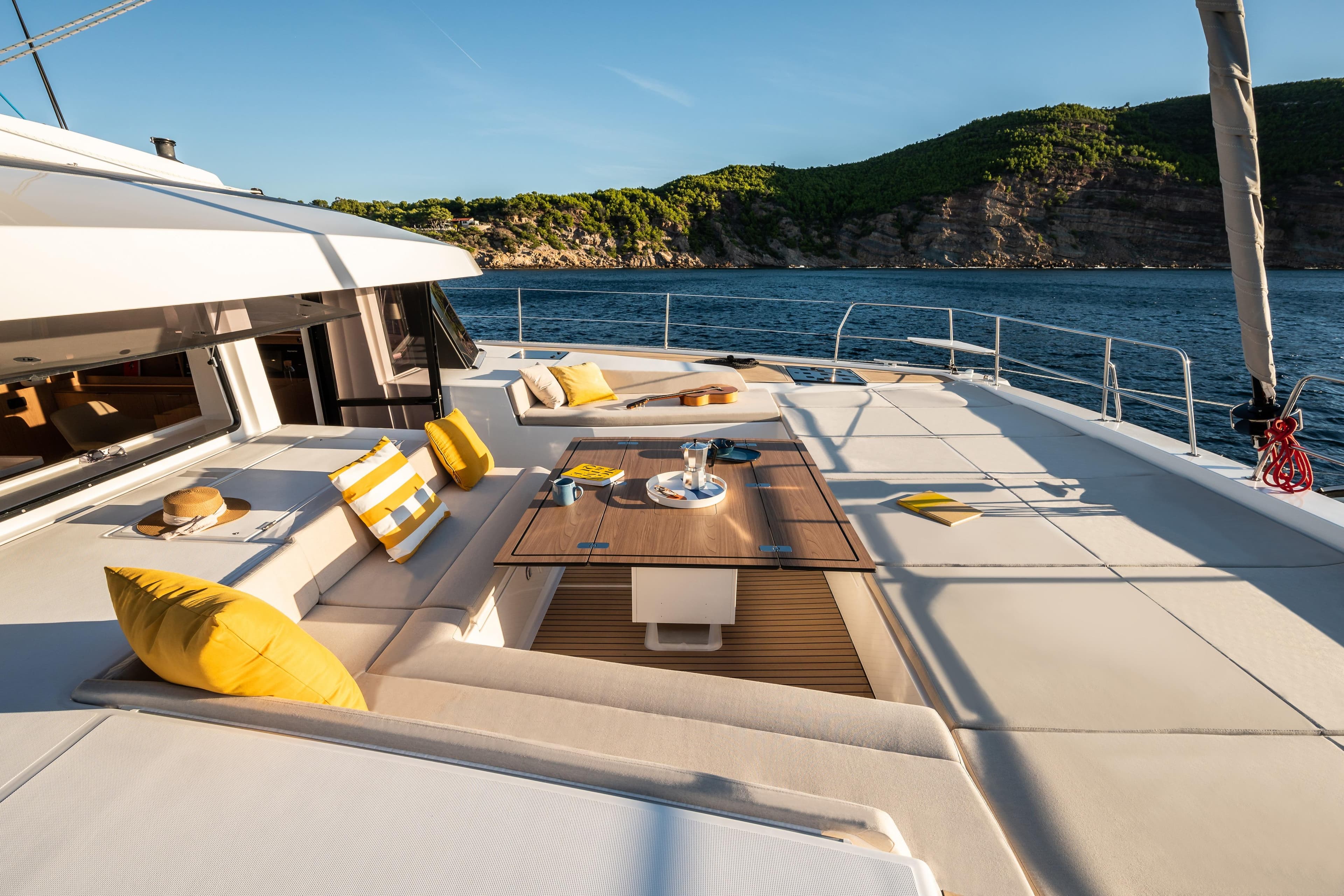 Luxurious Bali 5.8 yacht deck with seating, ocean view, and vibrant cushions, 2026 model.