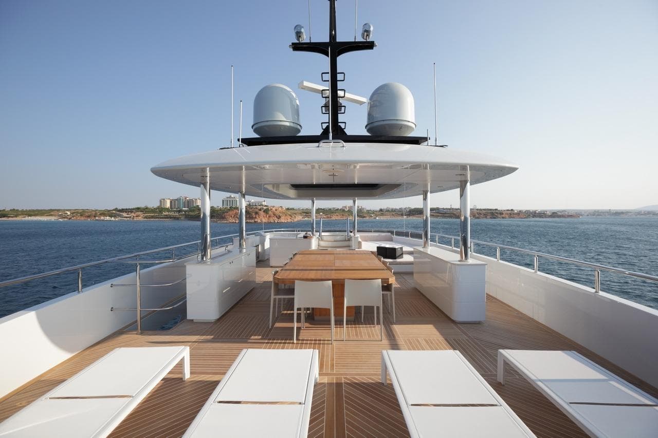 Luxurious 2013 LOGOS MARINE Curvelle 33.7m yacht deck with seating and ocean view.