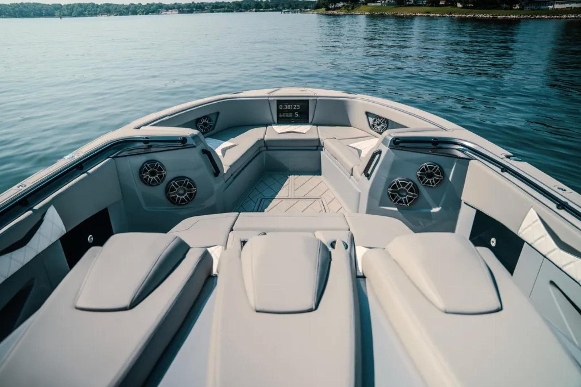 Luxurious interior of 2026 Deep Impact 499 Sport boat on calm water.