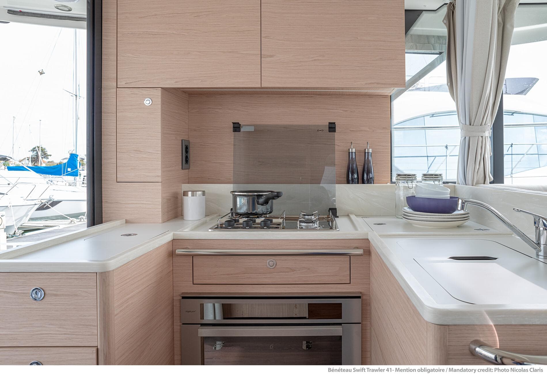 Modern kitchen interior of 2025 Beneteau Swift Trawler 41 Fly yacht.