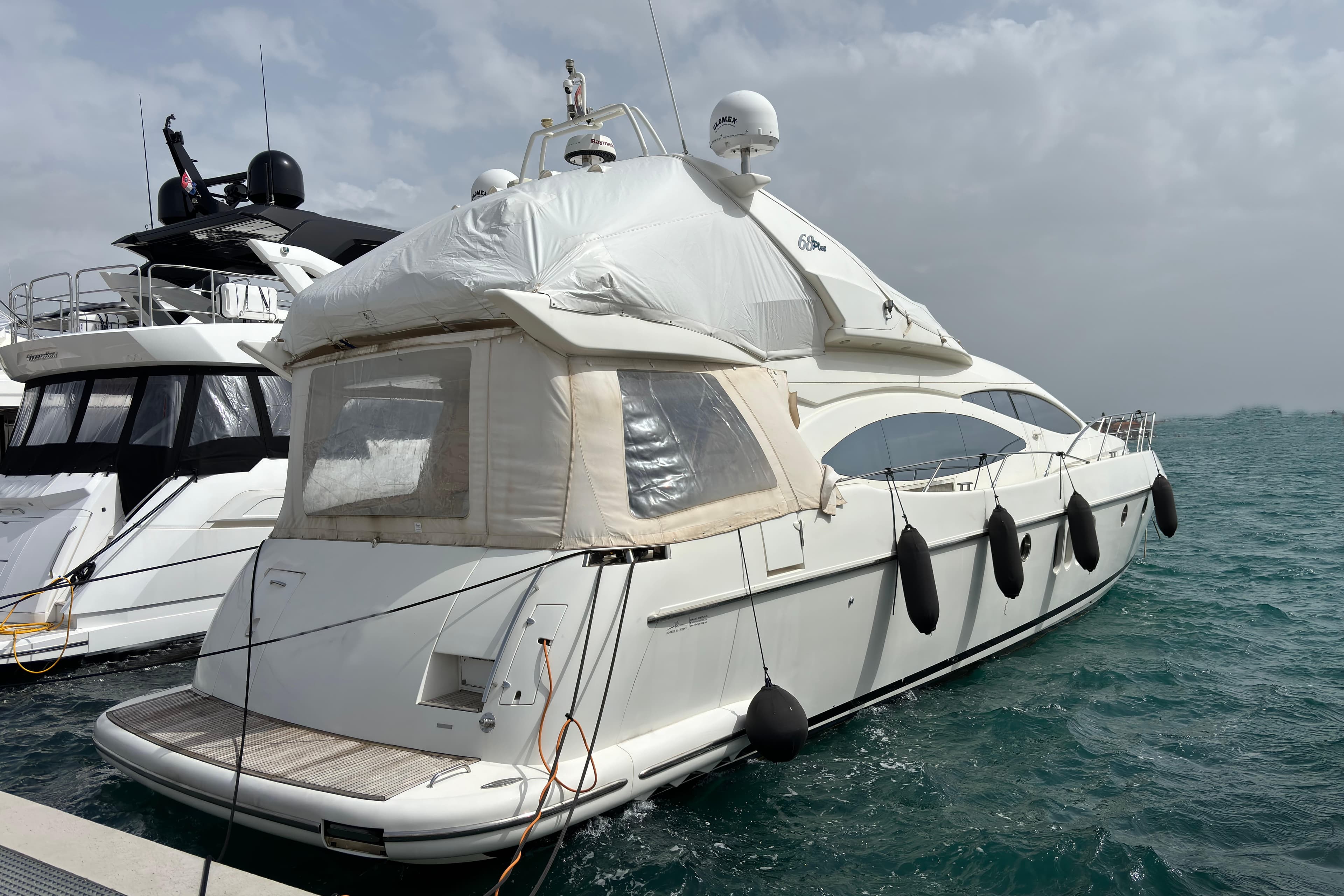 2002 Azimut 68 Plus yacht docked at harbor.