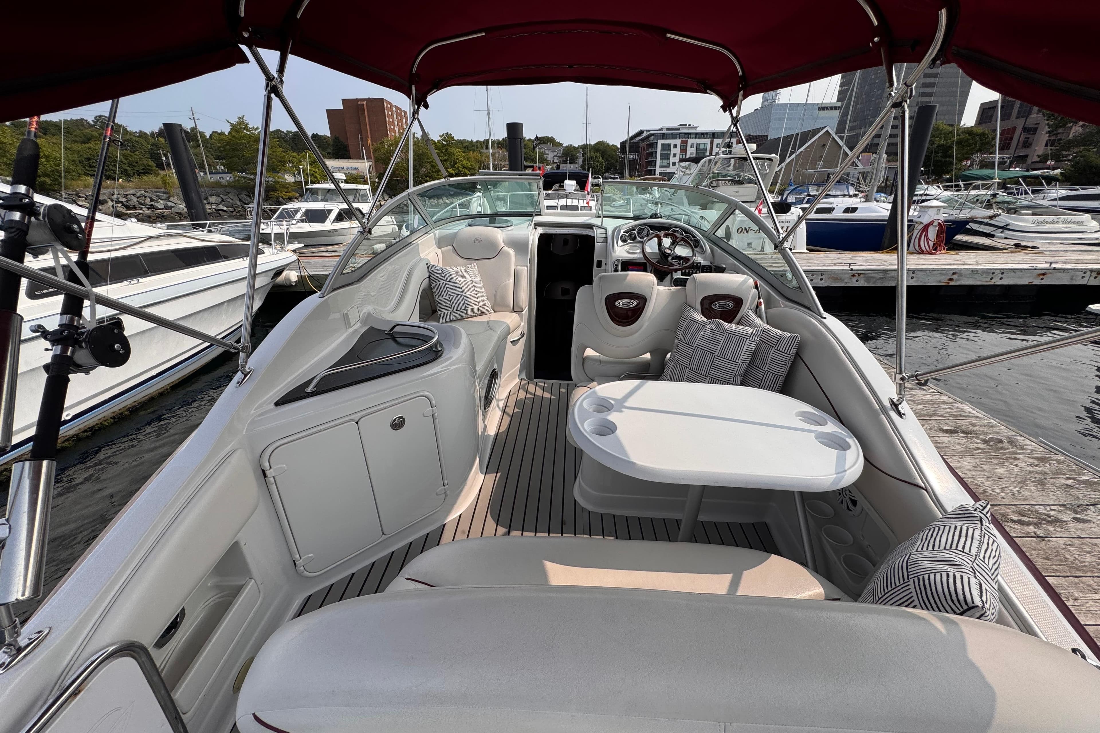 2007 Crownline 270 CR boat interior with seating, table, and dashboard at marina.