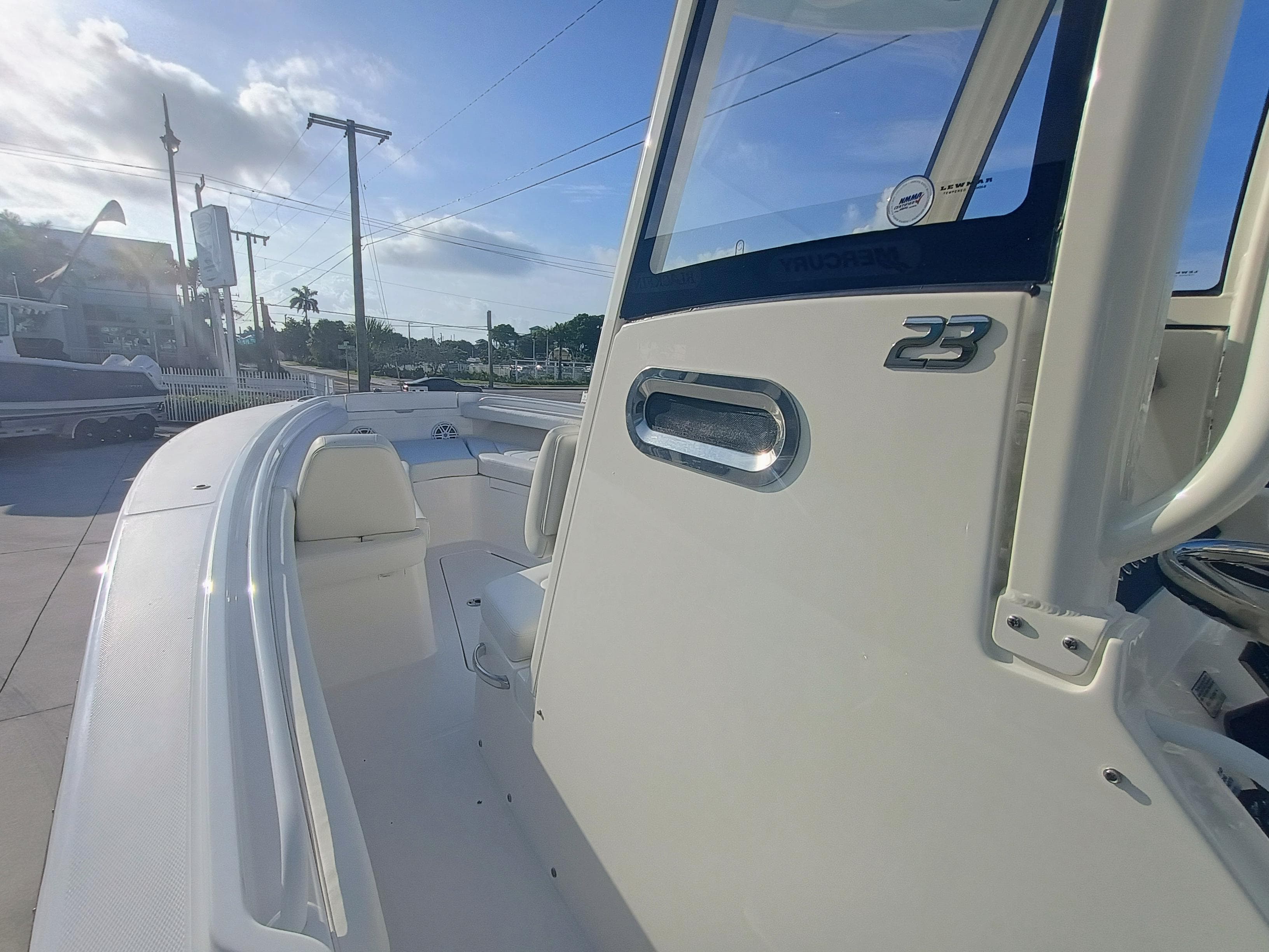 2025 Regulator 23 boat, sleek design, white exterior, sunny day, marina background.