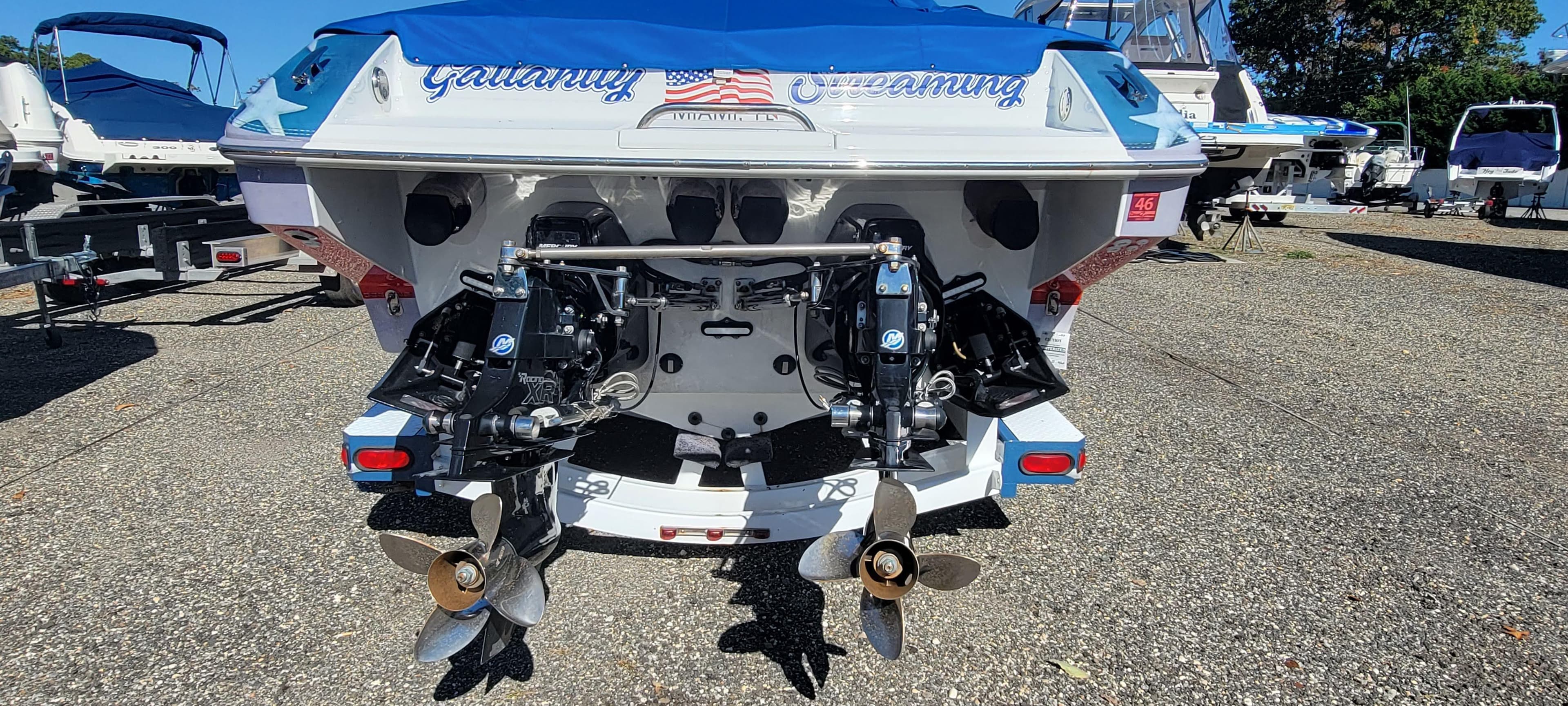 2004 Formula 382 FASTech boat rear view with dual propellers in a marina setting.