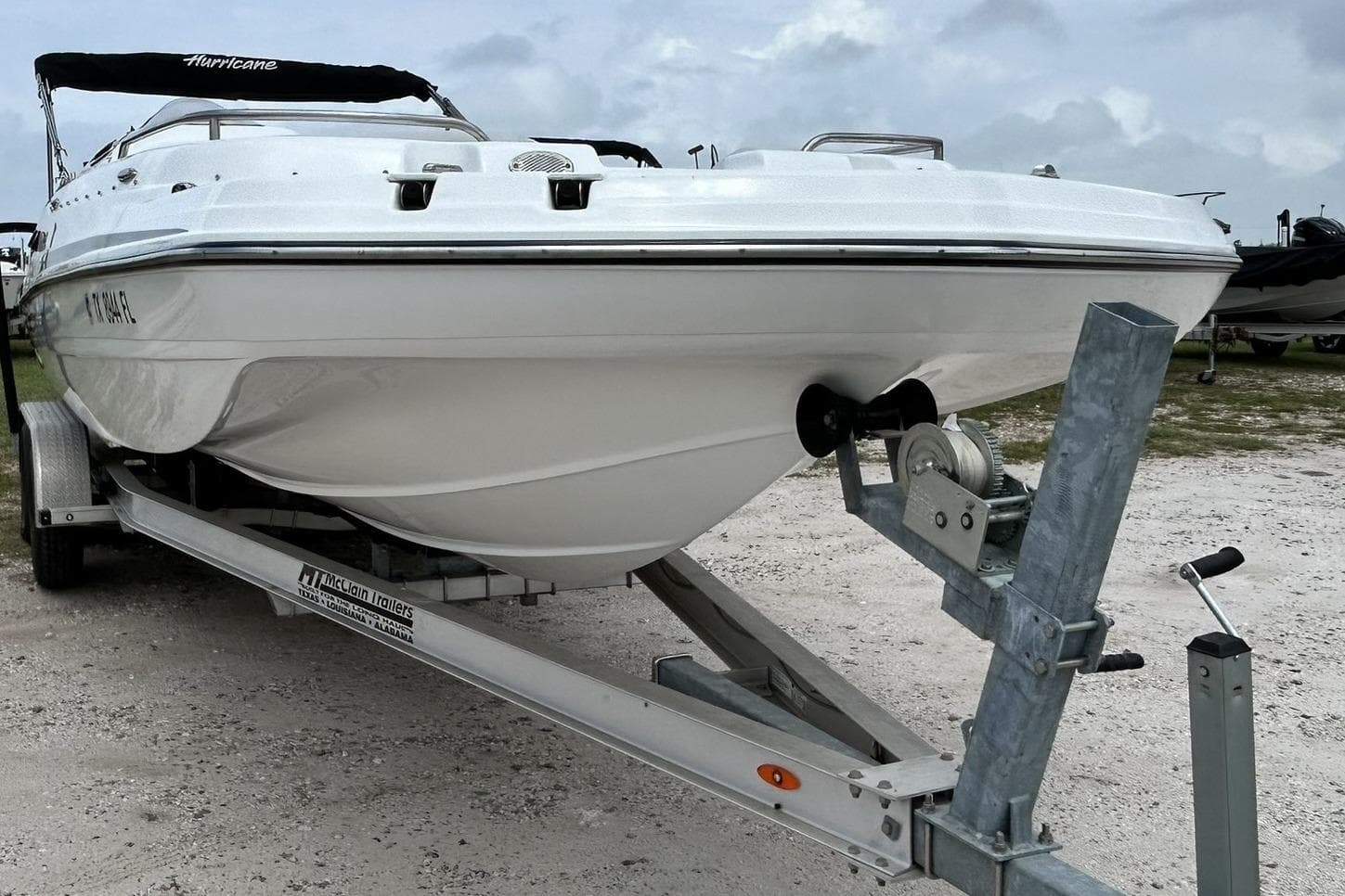 2018 Hurricane SunDeck Sport 232 OB boat on trailer, ready for transport.