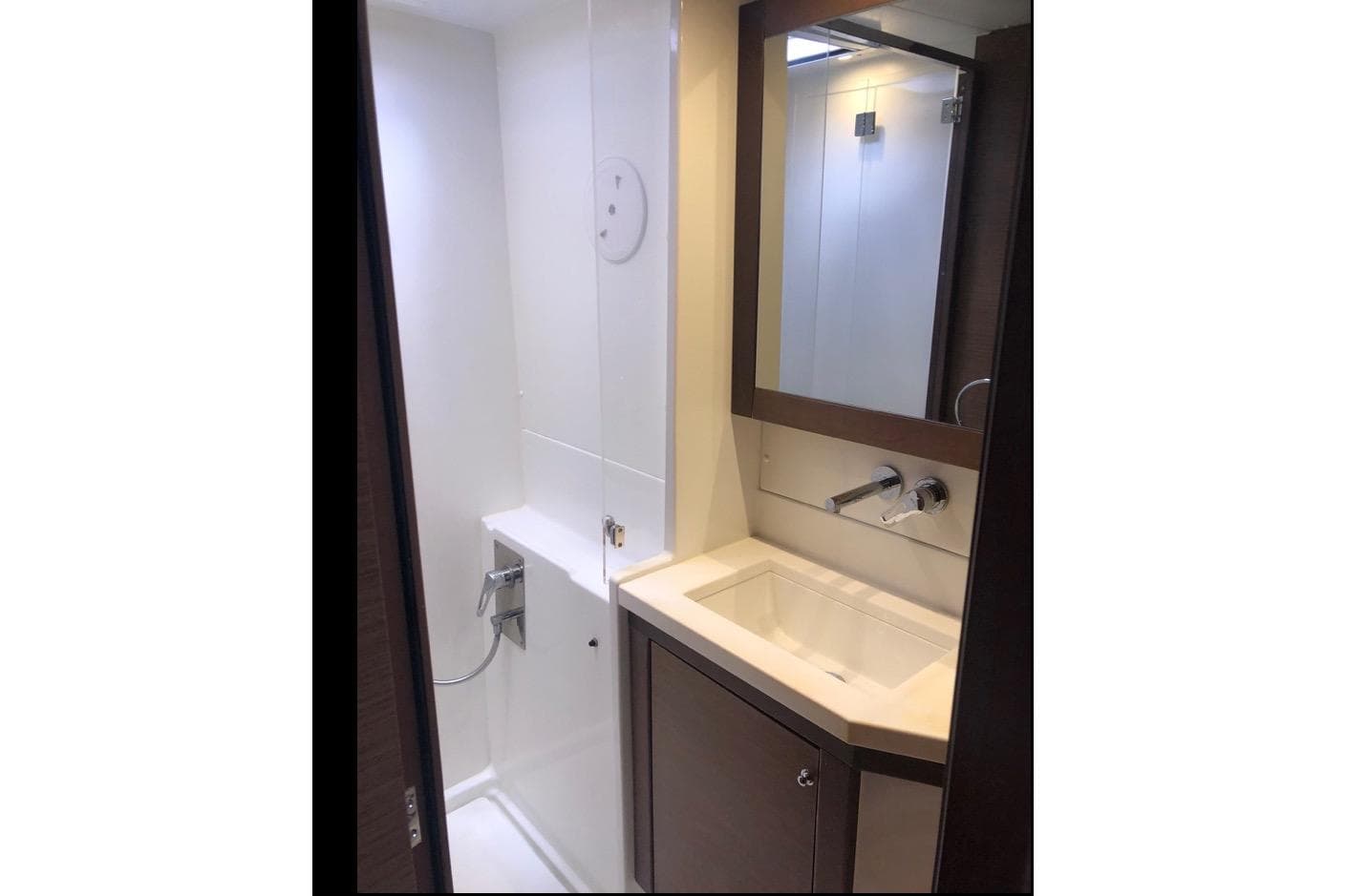 Modern bathroom interior of 2018 Lagoon 450 F yacht, featuring sleek sink and shower.