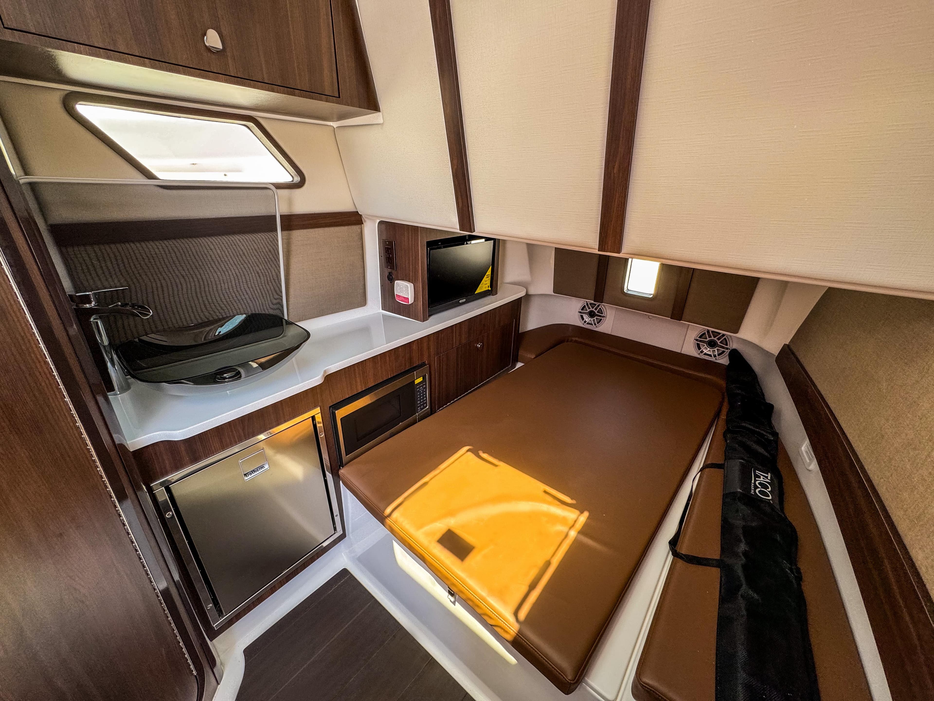 2025 Edgewater 370CC cabin interior with kitchenette, bed, and modern amenities.