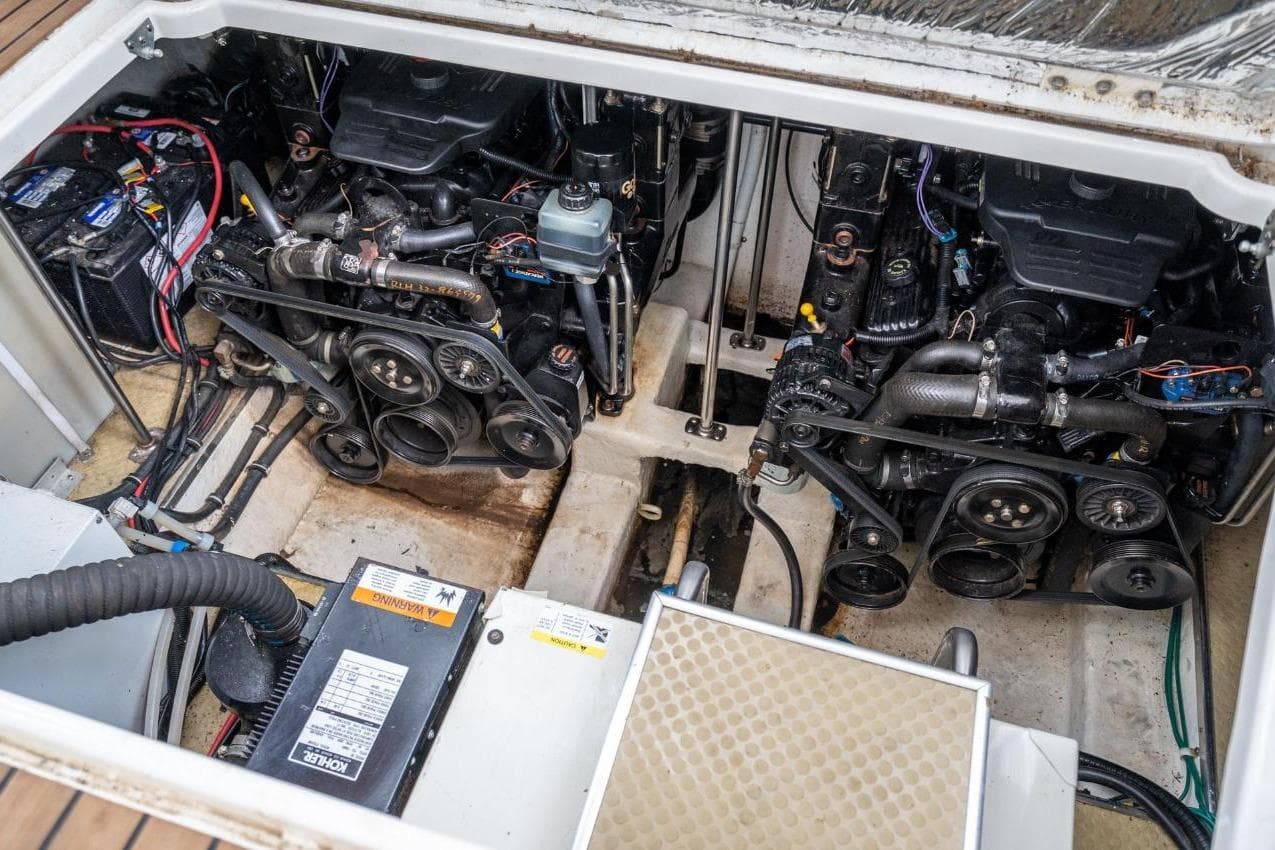 Engine compartment of a 2002 Larson Cabrio 330 boat, showing dual engines and wiring.